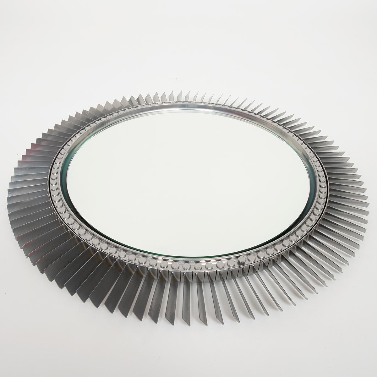 A wall mirror fitted to the engine fan blade from a Rolls Royce Avon jet engine, which powered the RAF Canberra Nuclear Bomber. Rolls Royce engines are complex and astonishingly well manufactured: this being one of a number of highly engineered jet