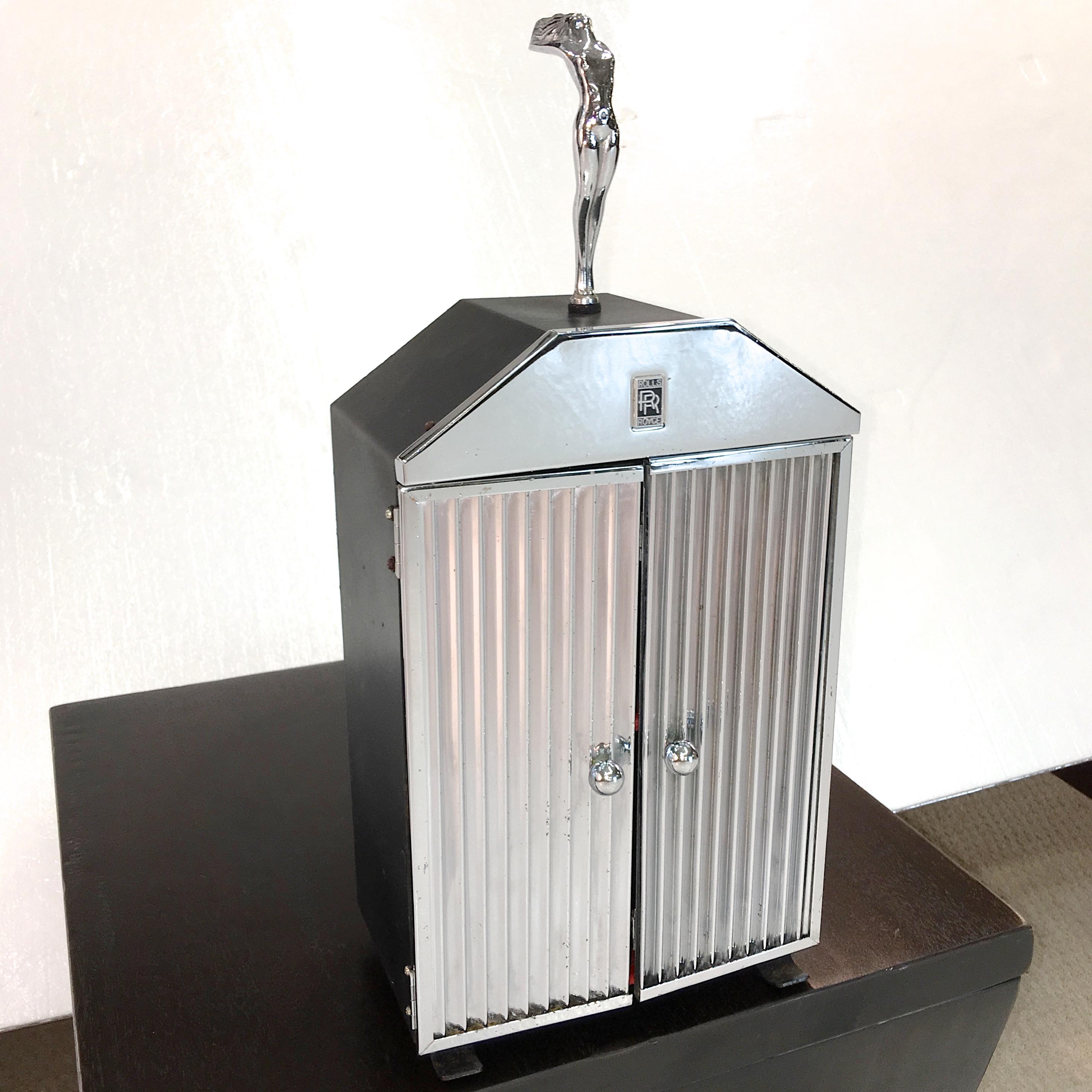 SATURDAY SALE - one week only. No further discounts. 15 Nov 2019

Very rare tabletop bar cabinet fashioned in the style of a Rolls Royce chrome radiator grill with fluted chrome doors with chrome ball pulls which open to a red and black finished