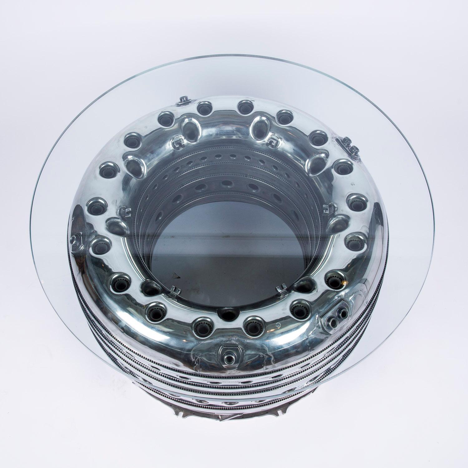 A Rolls Royce Pegasus jet engine annular ASM combustor chamber table, with 18 mm toughened glass top.


The unique Pegasus engine powers all versions of the Harrier family of multi-role military aircraft. 

The Rolls-Royce Pegasus is a turbofan