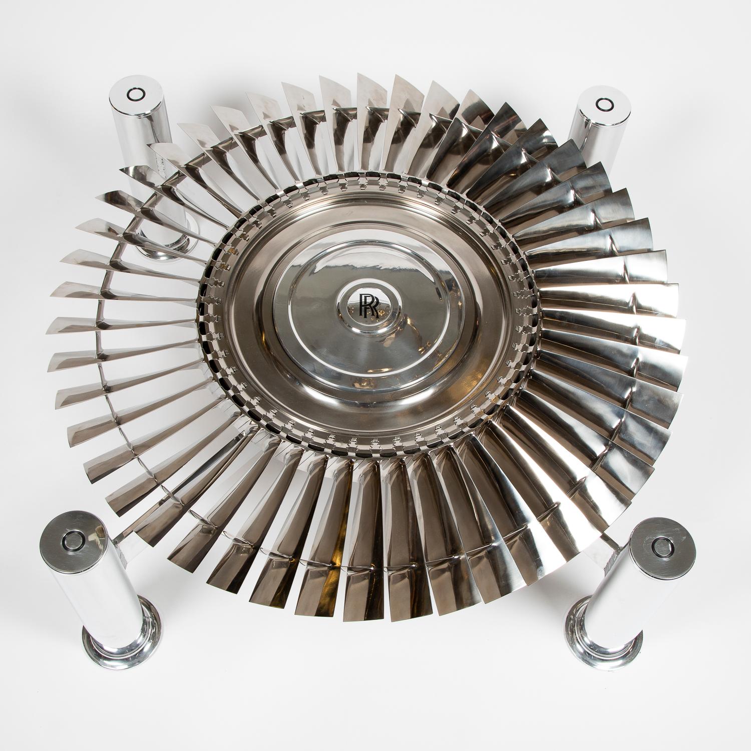 An aluminum coffee table incorporating a Rolls Royce Pegasus titanium turbine.

With central rotating turbine.

4 foot square toughened glass top.



The unique Pegasus engine powers all versions of the Harrier family of multi-role military