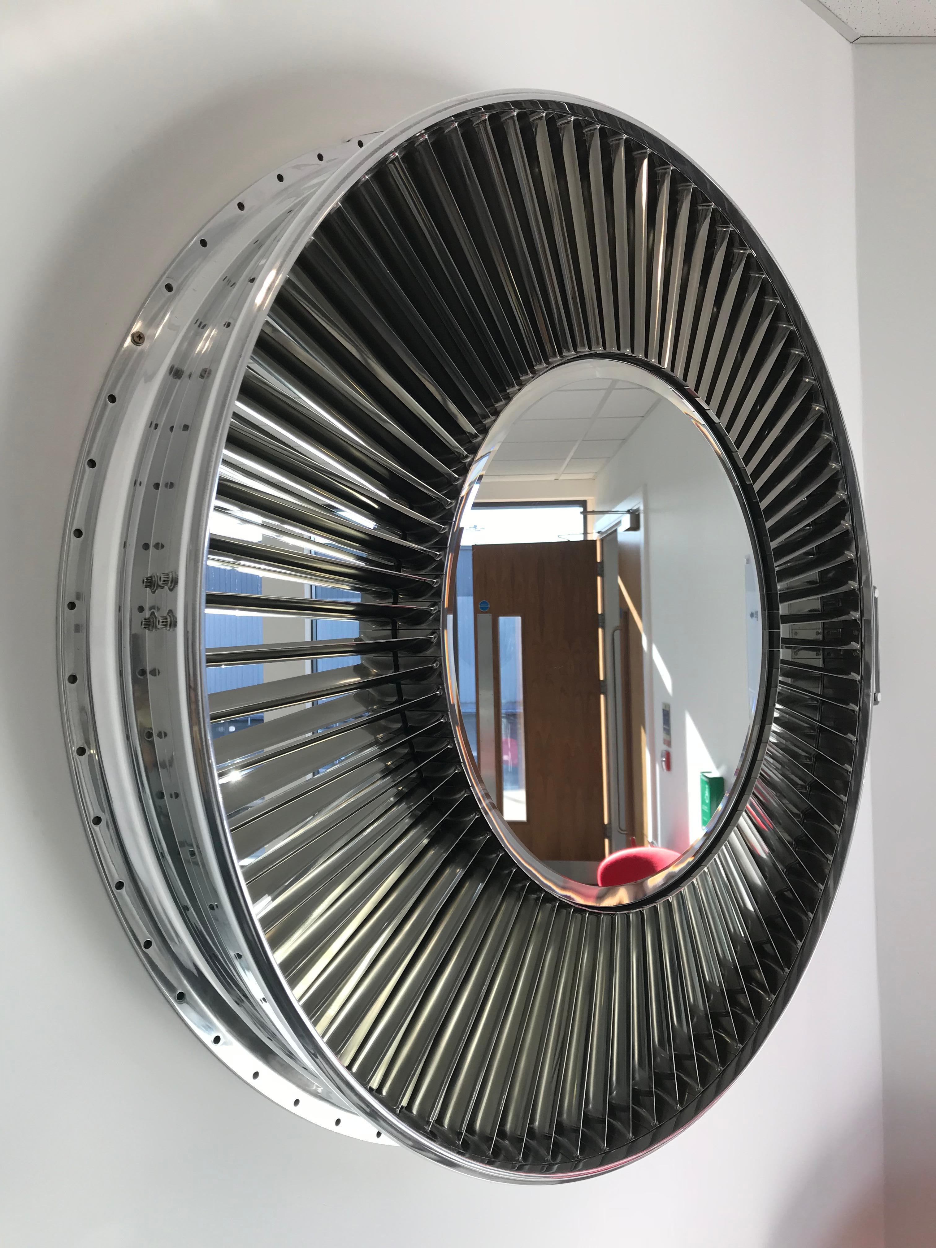 Crafted from a Pegasus (Sea Harrier Jump Jet) original engine casing, our skilled craftsmen have created a very detailed, highly polished mirror.
The piece comprises two mirrors, one central and one behind the 74 individually polished titanium