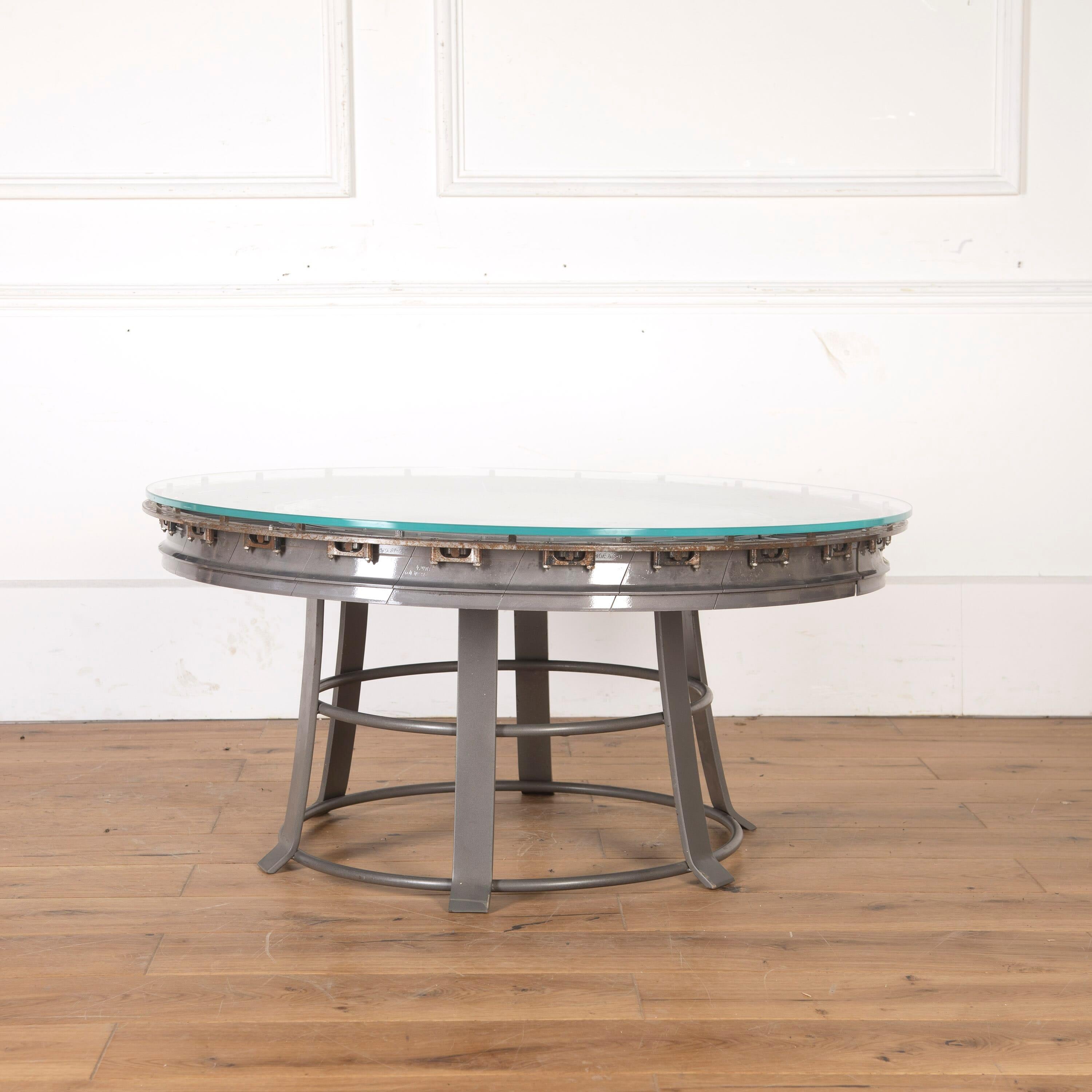 Spectacular glass-topped table, made from a turbine stator disc removed from a Rolls Royce Olympus TM3B gas turbine which belonged to the Royal Navy. 

The engine was removed from one of the invincible class aircraft carriers, and probably served