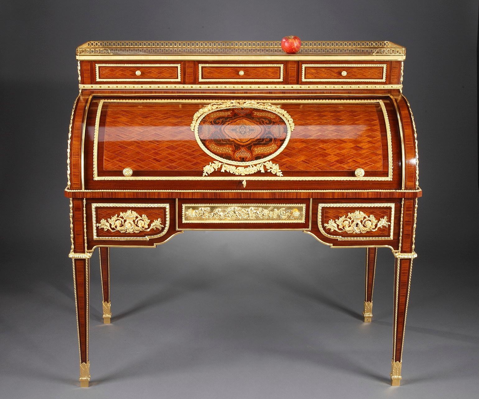 Remarkable Louis XVI style rolltop writing desk with marquetry latticework pattern. The front of the desk features six drawers. The rolling cover is embellished with a beautiful marquetry medallion surrounded by ormolu garlands. It opens to reveal