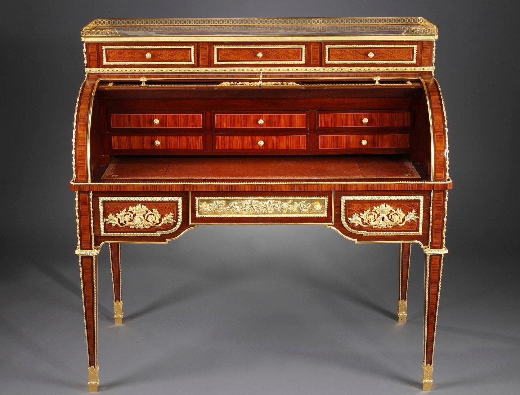 Remarkable Louis XVI style rolltop writing desk with marquetry latticework pattern. The front of the desk features six drawers. The rolling cover is embellished with a beautiful marquetry medallion surrounded by ormolu garlands. It opens to reveal