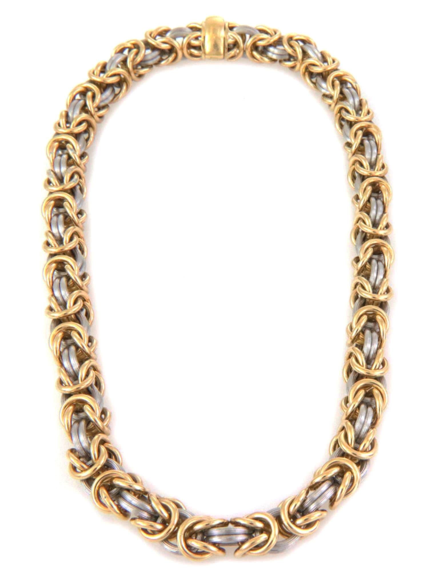This is a gorgeous fashionable necklace from designer ROM Germany, crafted from 18k yellow gold and platinum featuring a 9mm thick byzantine links with polished yellow gold and fine fluted platinum ring links. The necklace secure with a slide slot