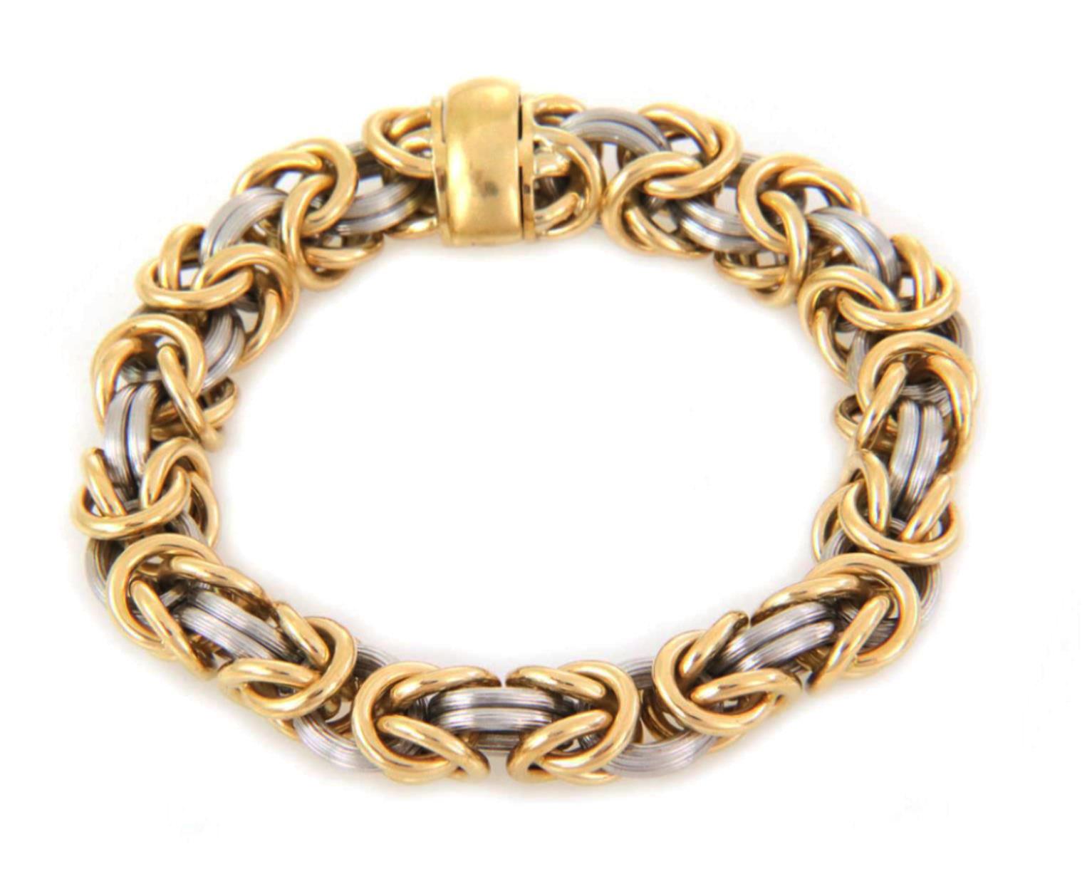 This is a bold fashionable bracelet from designer ROM Germany, crafted from 18k yellow gold and platinum featuring a 8mm thick byzantine links with polished yellow gold and fine fluted platinum ring links. The bracelet secure with a slide slot snap