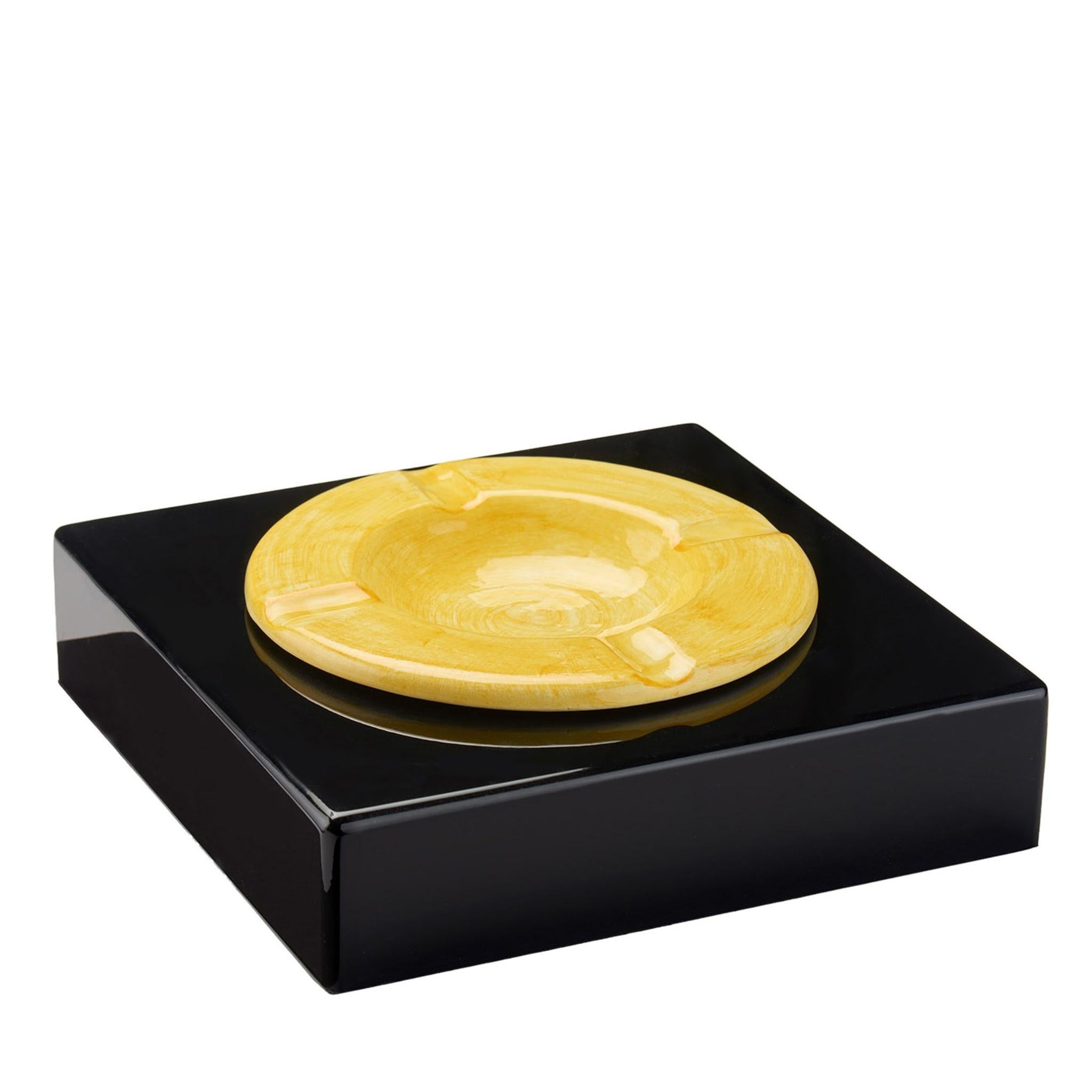 Turning an everyday object into a refined icon of contemporary design, this ashtray is a sublime showcase of artisanal craftsmanship. It features a round classic shape, handmade of ceramic and painted in a delicate yellow shade, enclosed in a