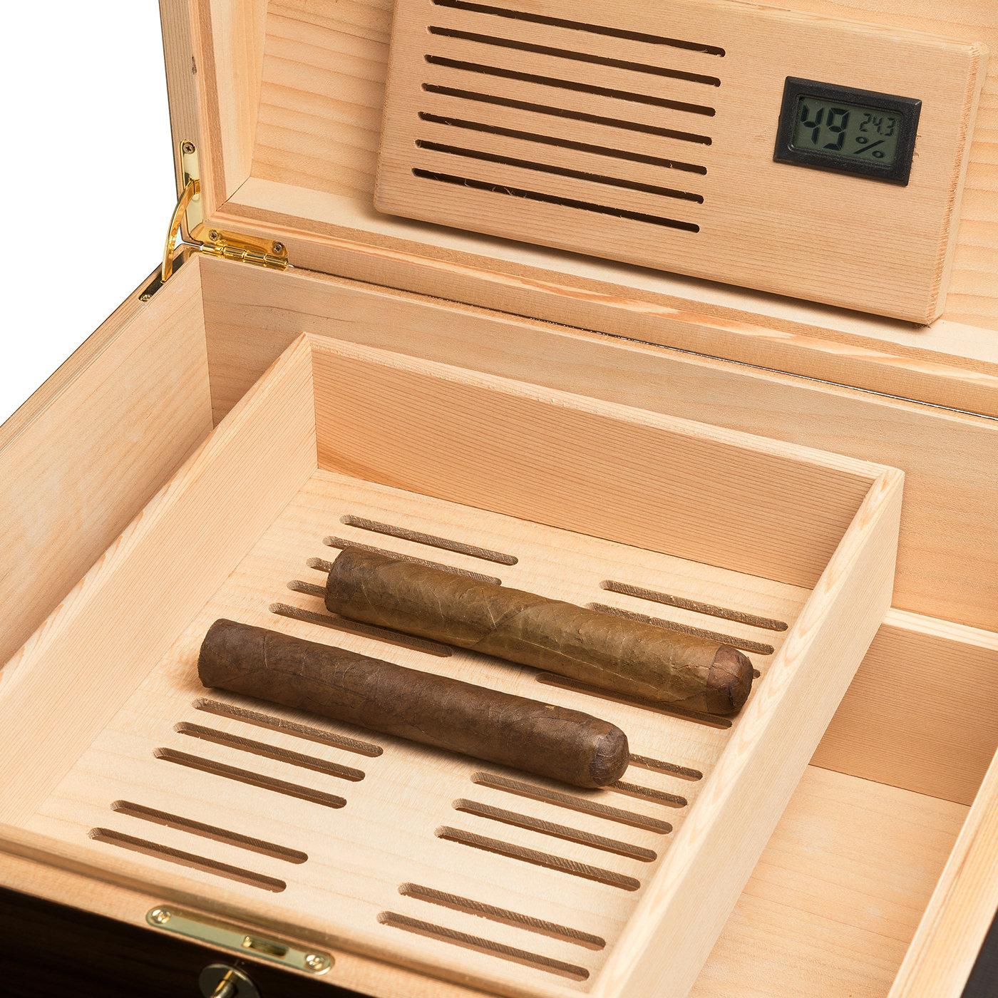 An elegant and refined collector's piece, this cigar case will add an accent of sophisticated flair to any modern or traditional interior. The perfect gift for a cigar lover, it flaunts a classic silhouette handcrafted of cedarwood, venereed in