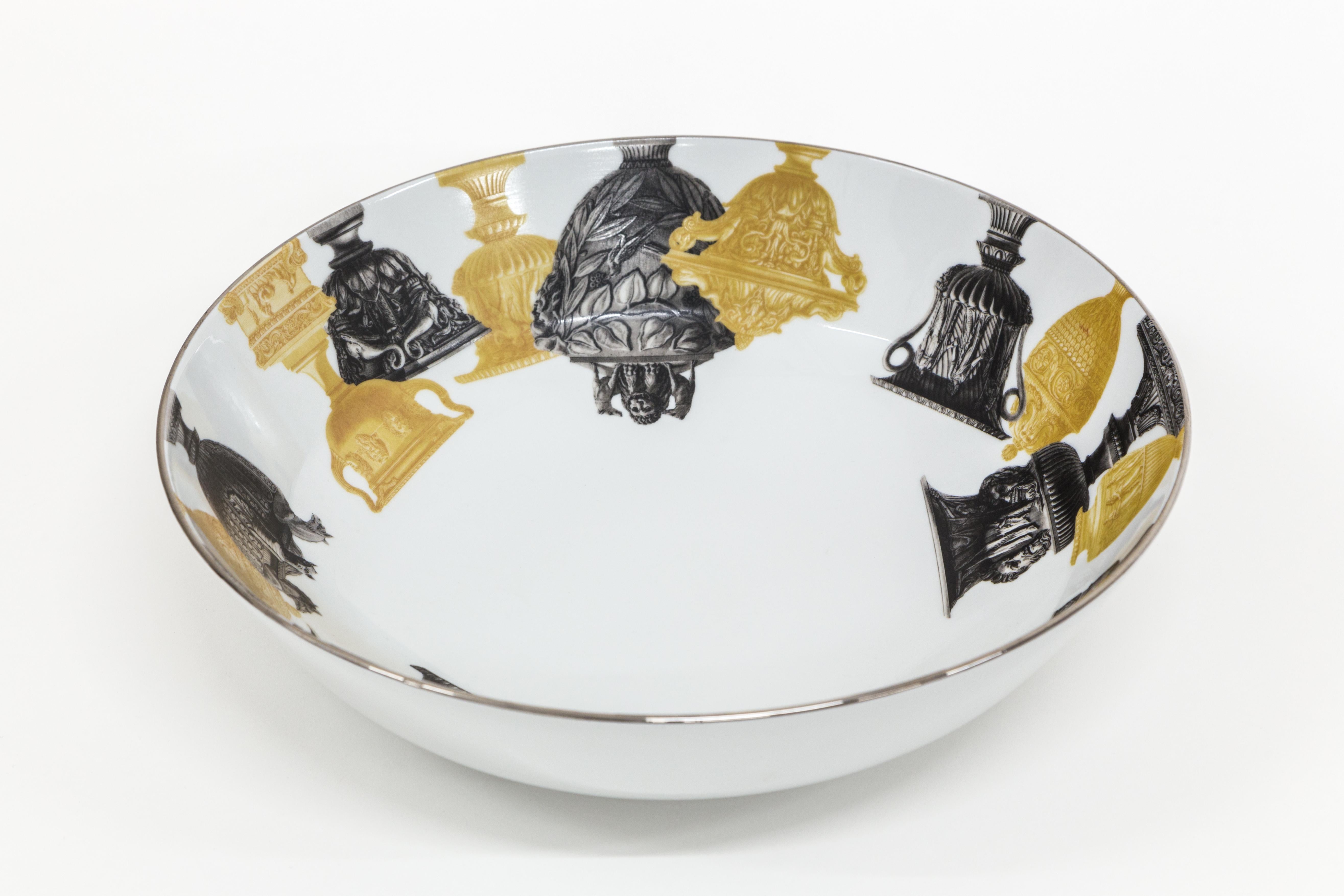 This 34cm diameter bowl is part of the Roma collection by Grand Tour By Vito Nesta. The very versatile shape is suitable as a fruit stand, table centerpiece or ornamental bowl on any shelf. An interplay of ancient vase and amphora designs surrounds