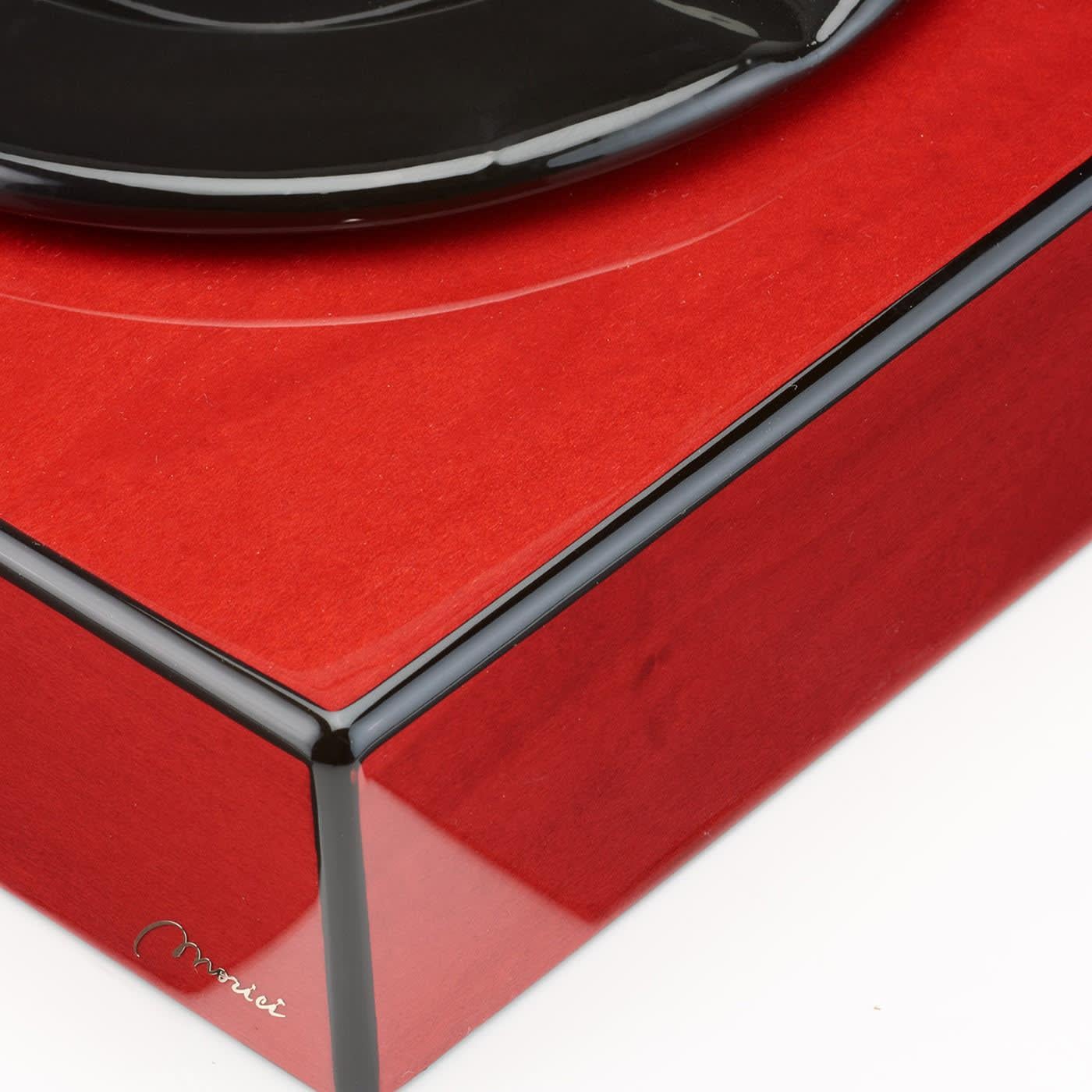 Distinguished by splendid natural veinings and grains, shining through polished red and black paint decorating its clean and classic shape, this ashtray turns an everyday object into an exclusive icon of contemporary design. Handmade of wood and