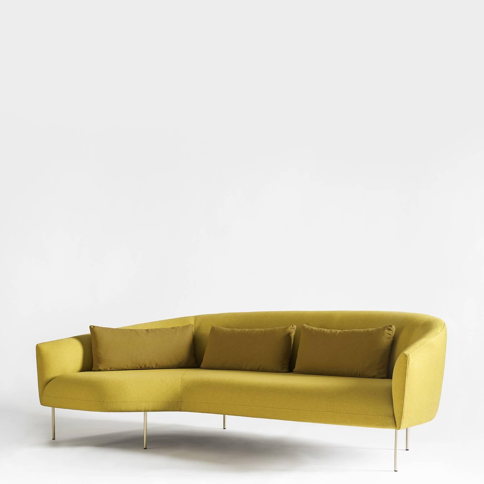 Designed by Jonas Wagell, this sofa is a jewel of contemporary decor and will enliven a modern living room, providing comfortable seating and a sophisticated accent. The curved silhouette of its cushions, upholstered with a bright yellow fabric,