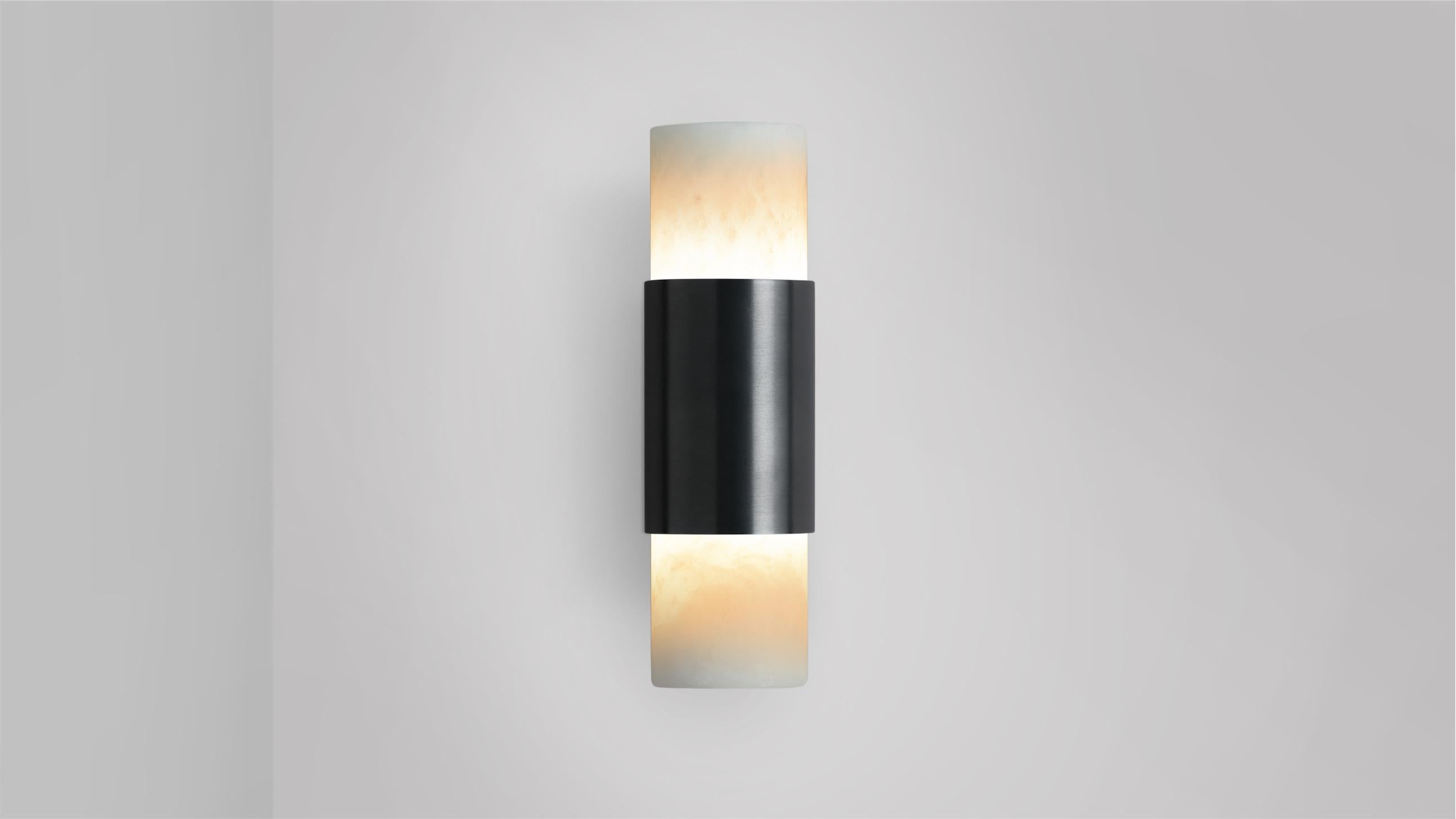 Roma wall lamp by CTO Lighting
Materials: bronze, alabaster.
Dimensions: D 8.5 x W 5.5 x H 19 cm
Available in satin brass and bronze.

Celebrating the simplicity of line and form, The Roma collection is designed to highlight the noble quality of