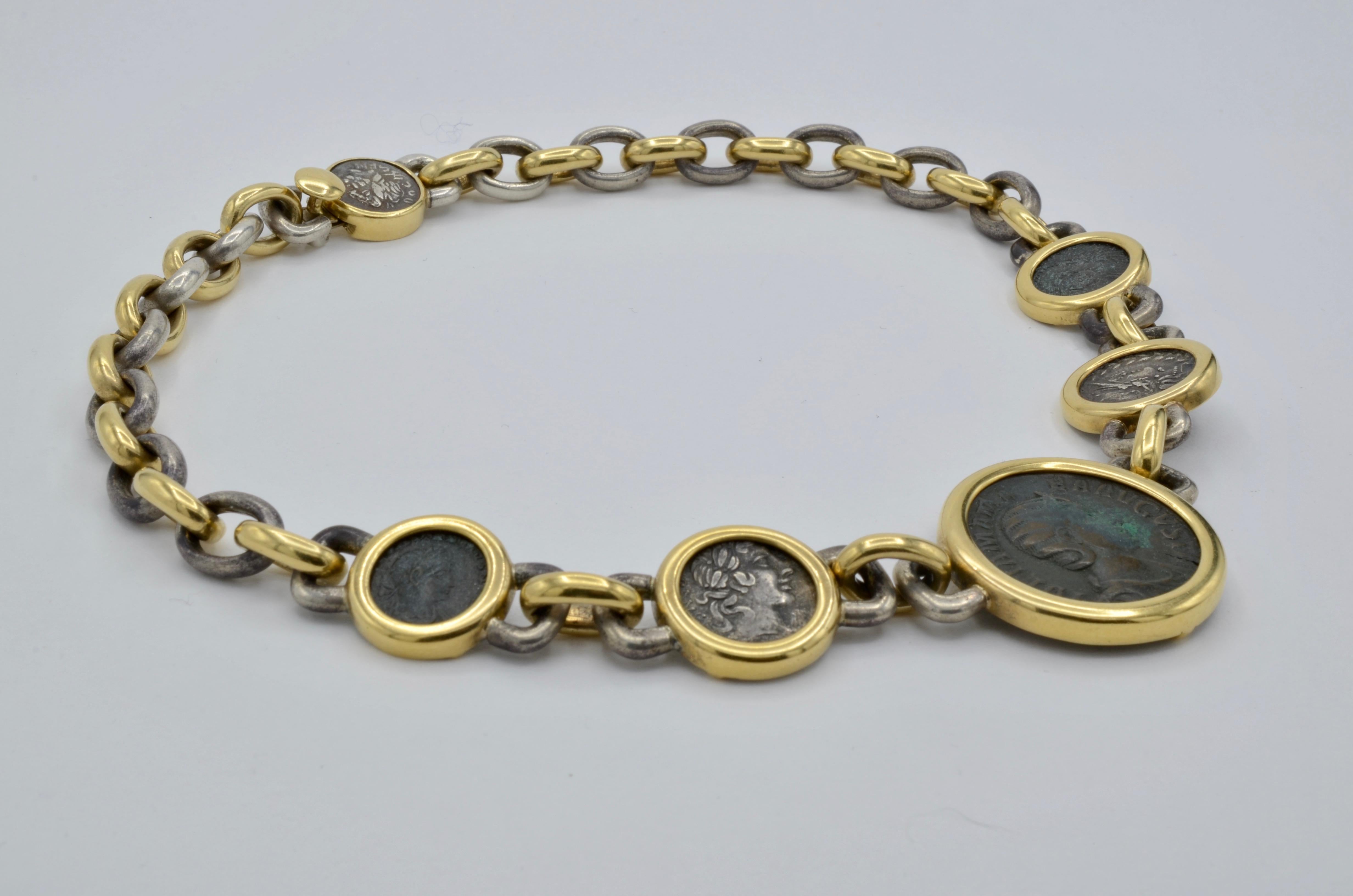 This old Roman coin necklace is beautifully thought out as all of the coins are well matched and set in heavy 18k yellow gold bezels. The interlocking links alternate between 18k yellow gold and sterling silver with a Roman coin in the back clasp.