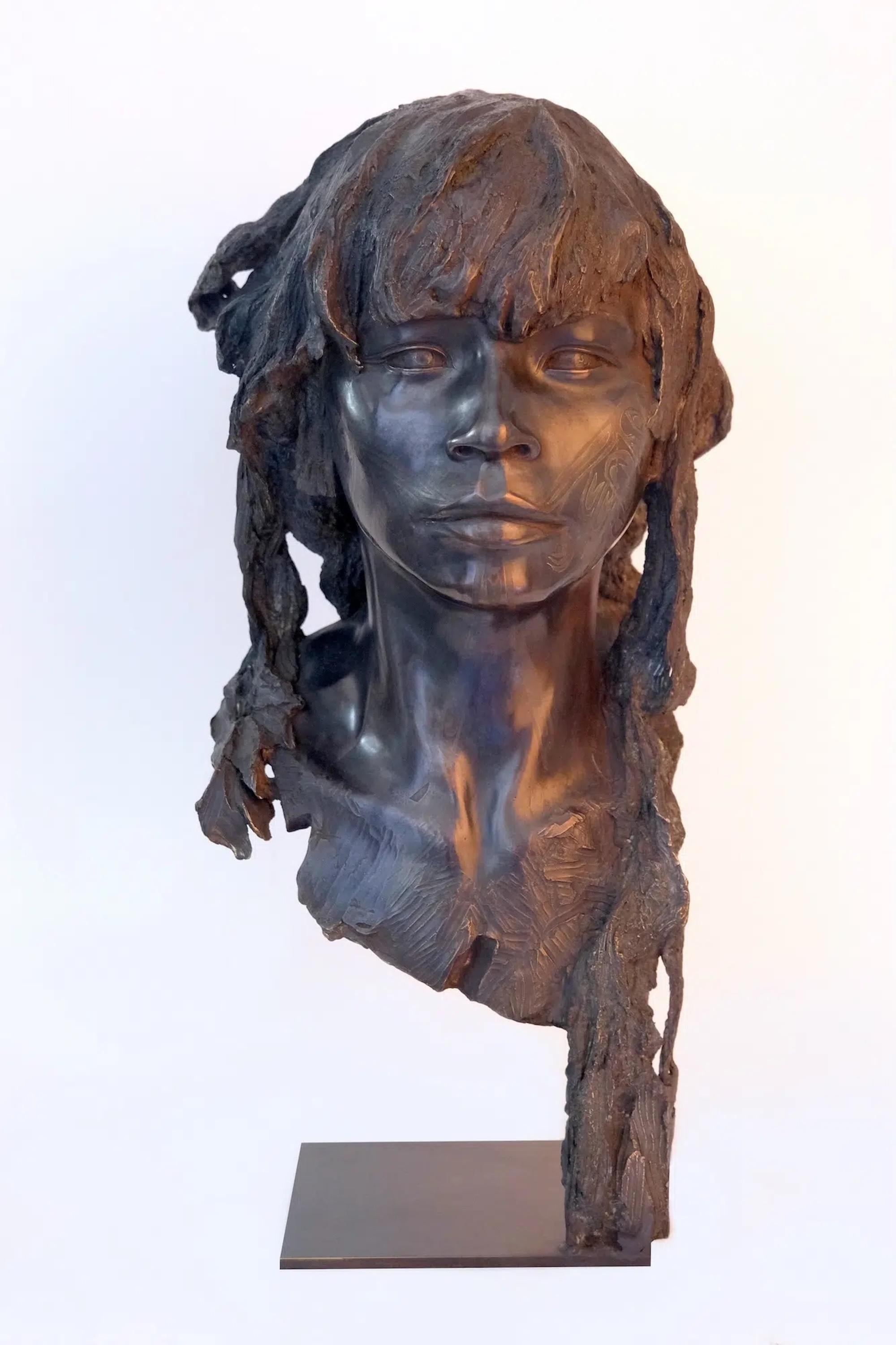 The Raven is a figurative bronze sculpture by French artist Romain Langlois, representing the face of a young man with long hair, his facial features engraved with a traditional tattoo. Dimensions are 64 × 30 × 31 cm (25.2 × 11.8 × 12.2 in)

The