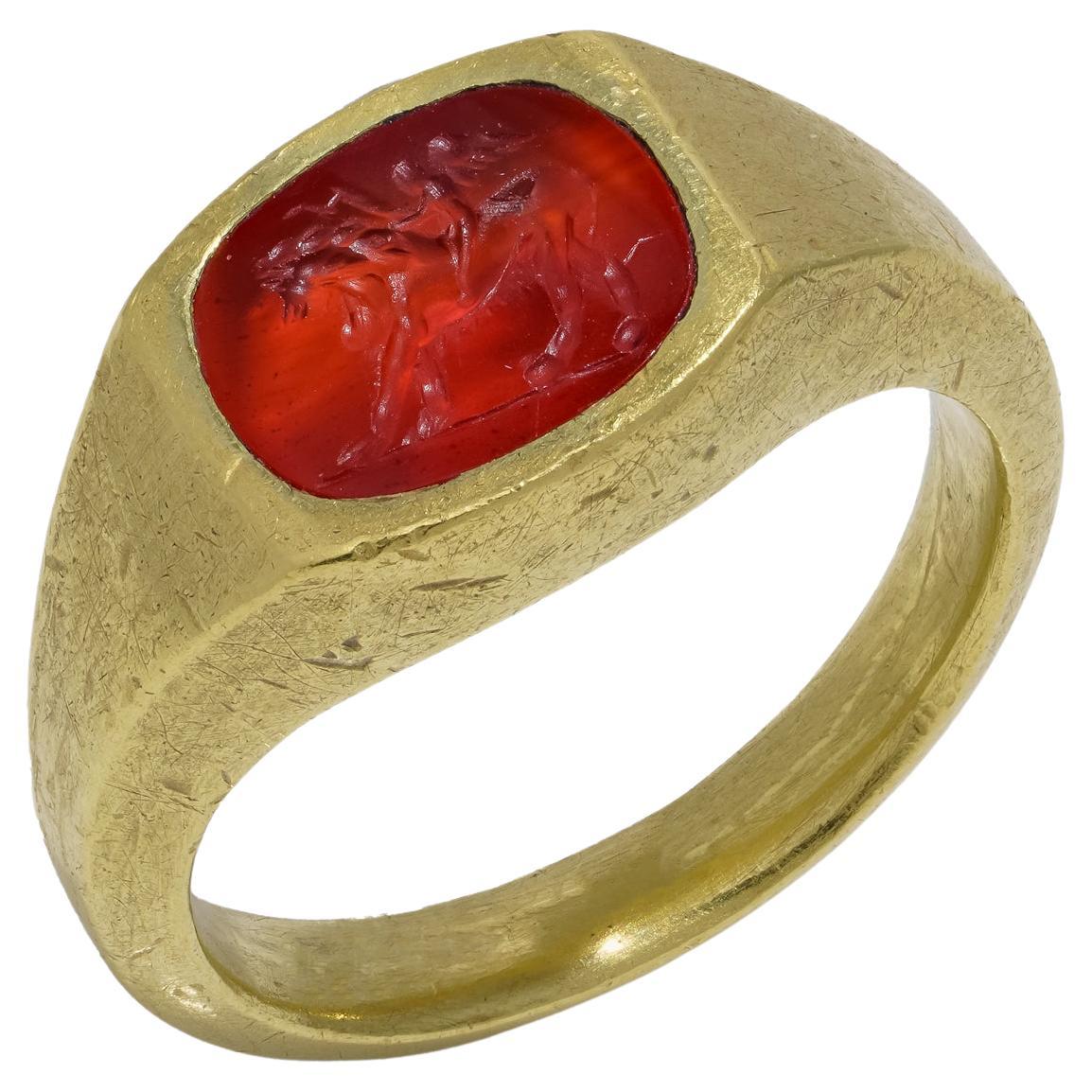 Roman carnelian intaglio with Cupid riding a Lion mounted in 22kt gold