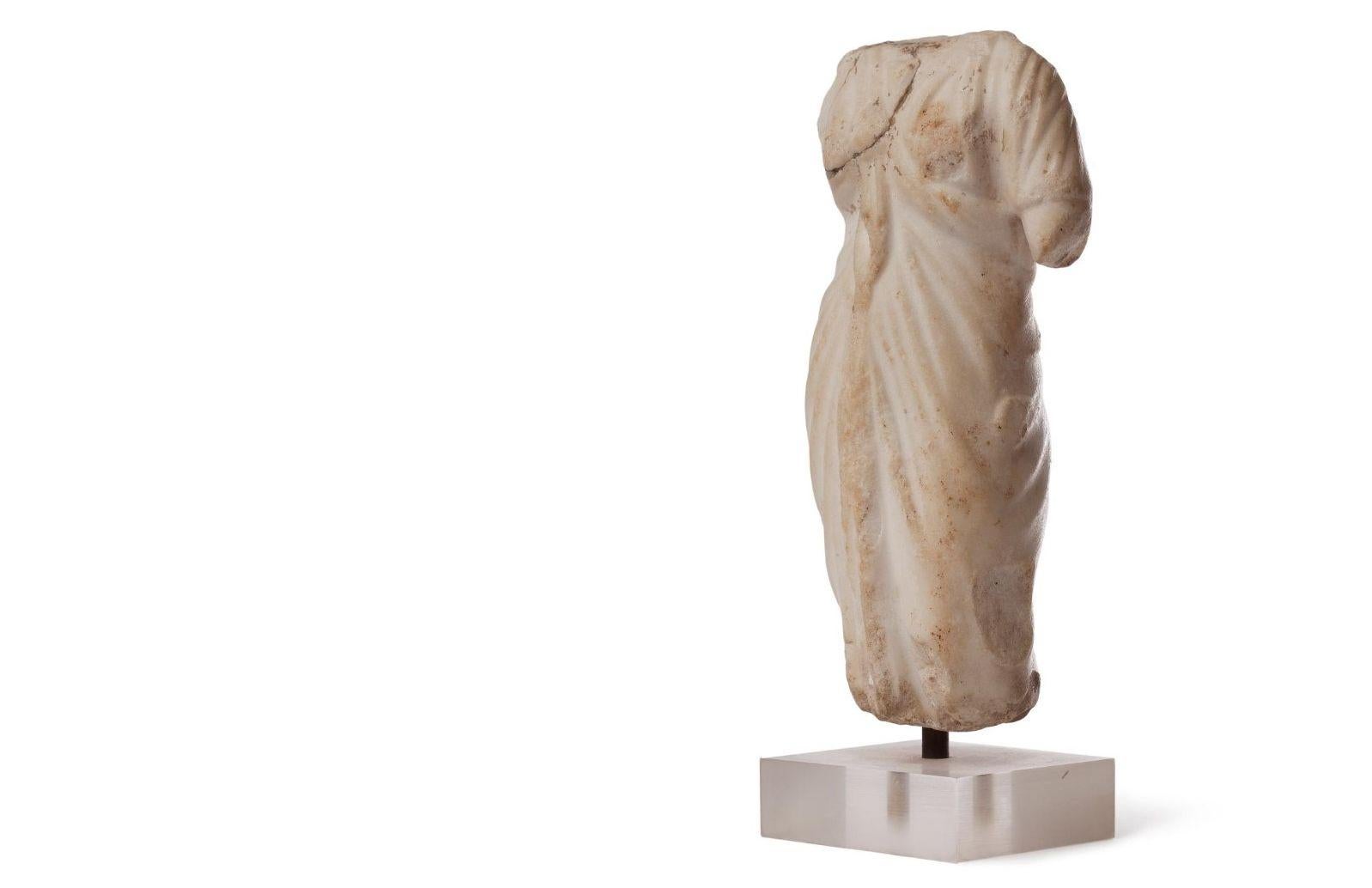 Beautiful Roman Oriental marble torso, most possibly depicting the Goddess Venus, draped with a Himation, the Greek Toga. Small defect on right shoulder.
Beautiful accent piece.
2nd-3rd century AD, Roman Oriental Provinces. A certificate by