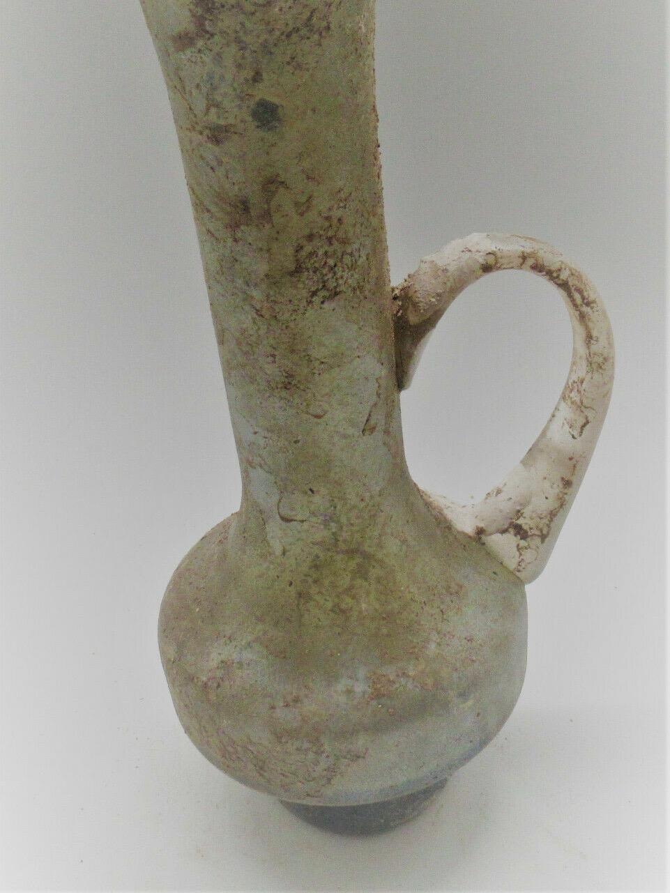 Museum qualityancient roman glass juglet with handle 200-300 AD
this is a lovely small vase, jar 26cm
total width with handle 13 cm
ancient roman glass
dark, silver, green, white fluorisent glass
¨aqua glasses¨.