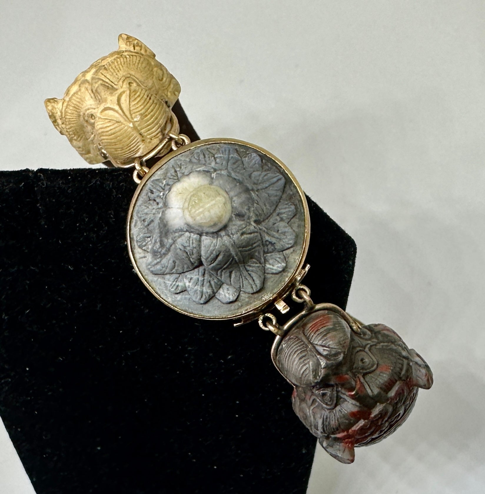 Indulge in a Museum Quality Antique Victorian Animal, Dog, or Lion, or Sea Serpent Lava Cameo Bracelet in Gold.  The extraordinary bracelet is exquisitely hand carved from Lava from the eruption of Mount Vesuvius.  The bracelet has a double animal