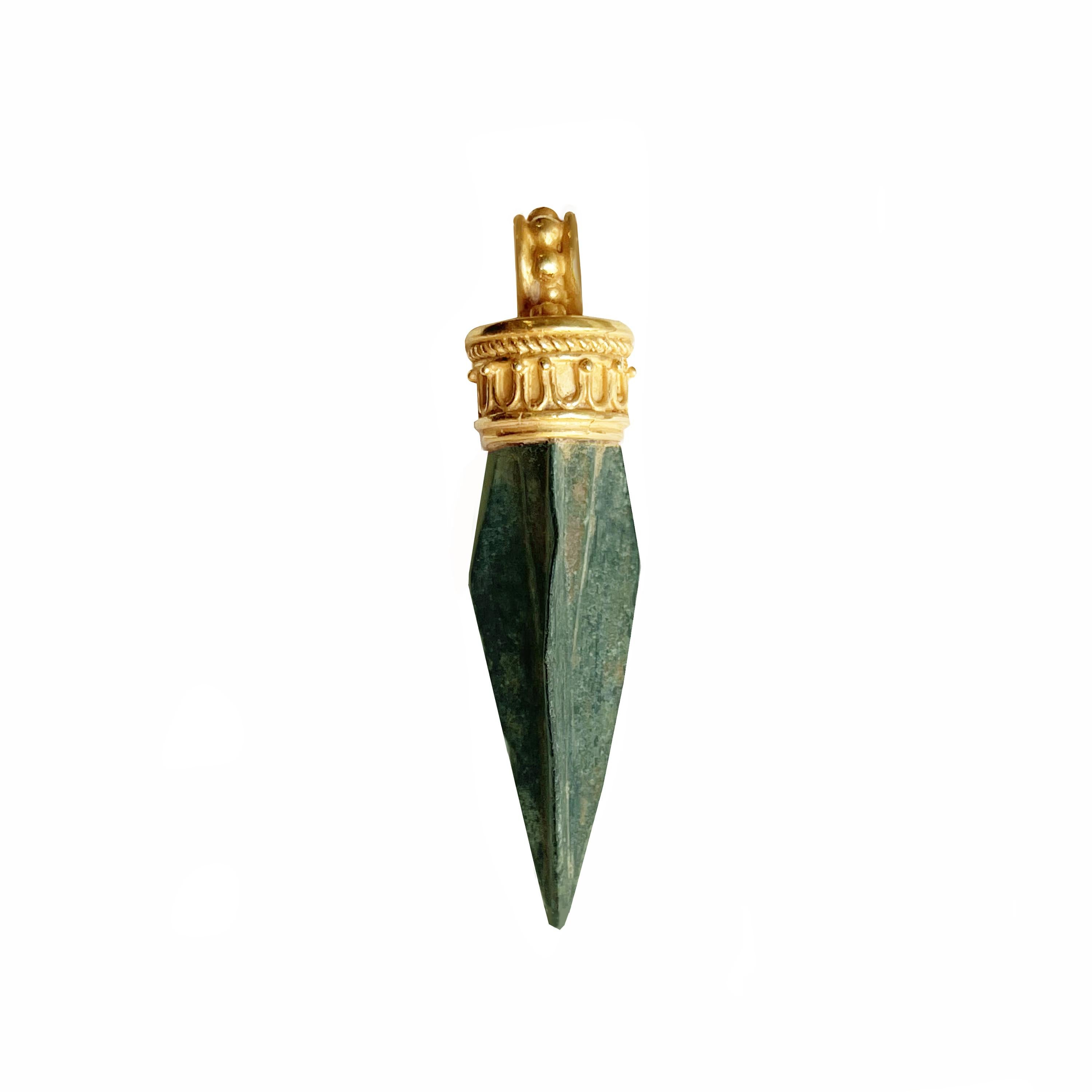 Small bronze arrowhead, olive-green patina,similar to examples found in the 