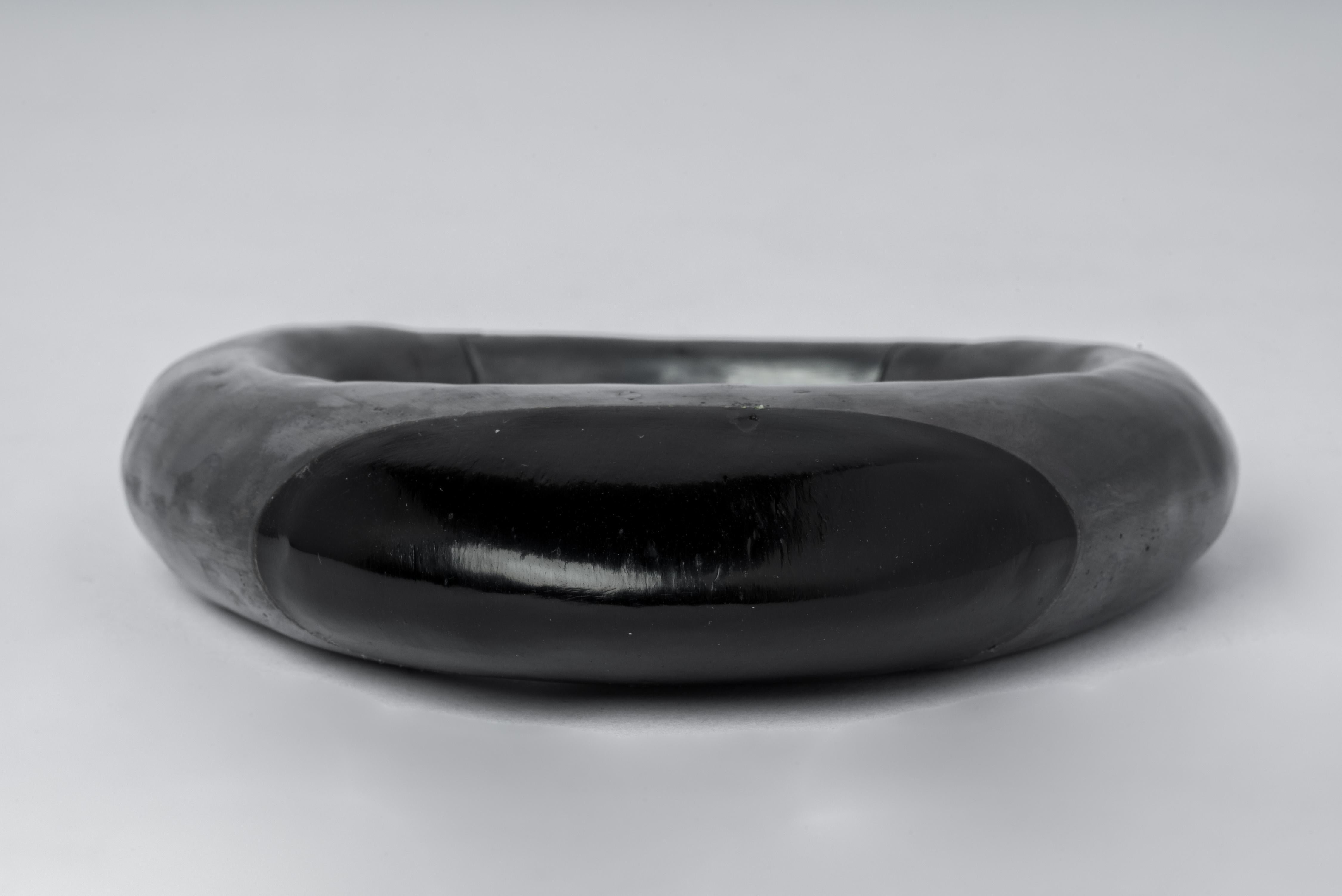 Bracelet in oxidized sterling silver and slab of JET, a fossilized coal. This item has elements that have been carved entirely by hand. This piece is 100% hand fabricated from metal plate; cut into sections and soldered together to make the hollow