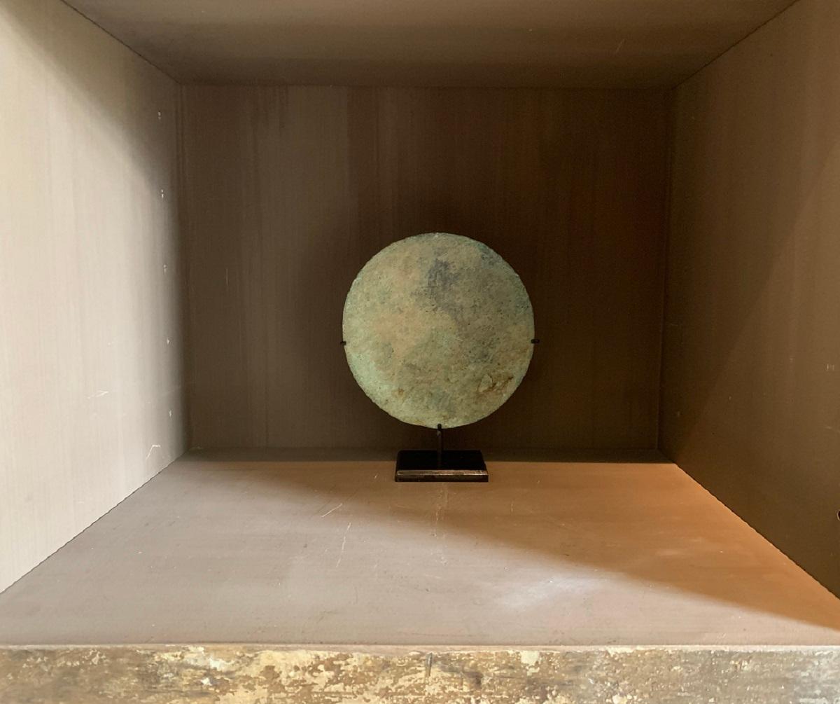 A large Roman bronze mirror, 1-3th century AD. Slightly Convex with beautiful color and incrustation.

Up until the 17th century mirrors (as we know them now) were very rare. Most people only got a glimpse of how they looked in water or stained
