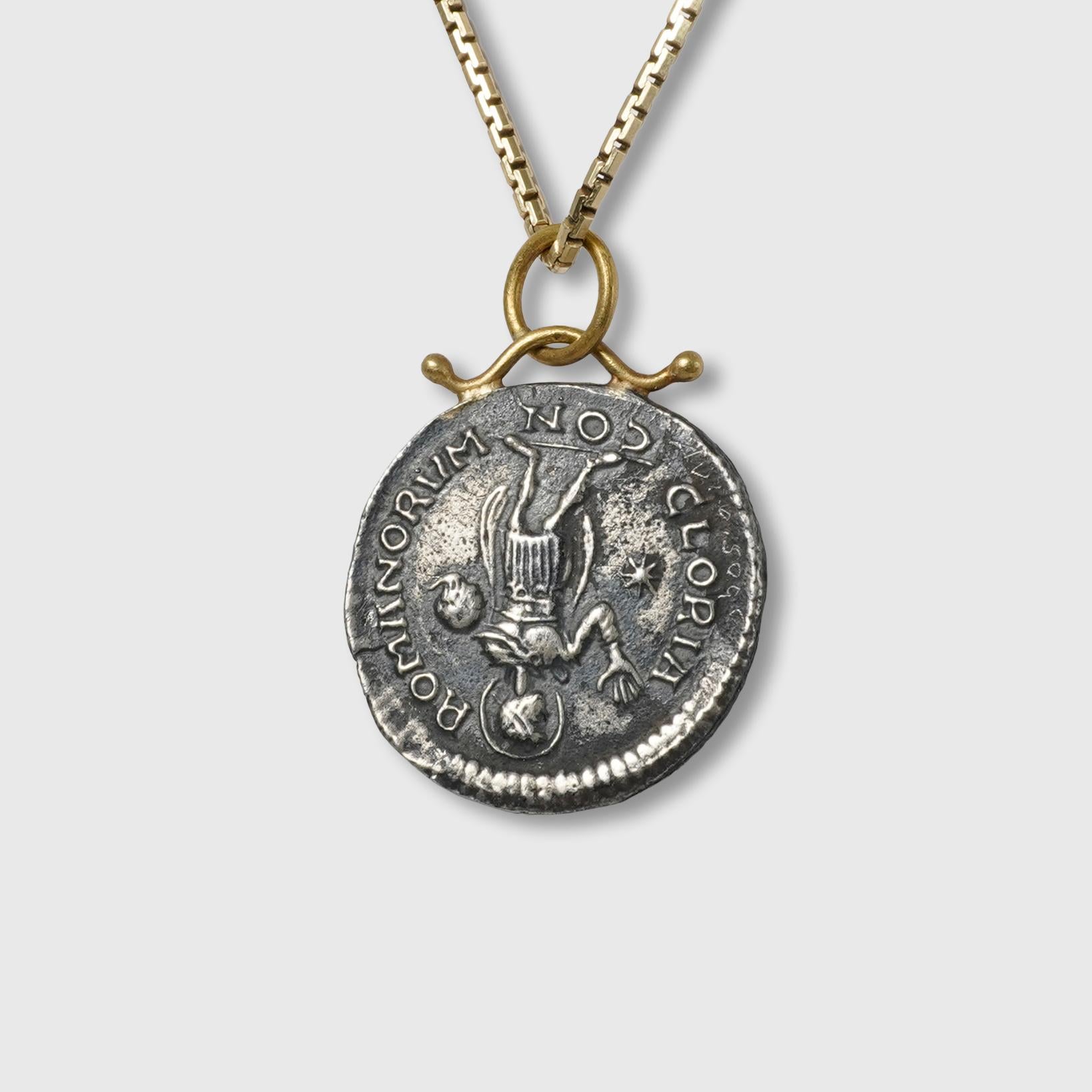 Roman Caesar Replica Coin Charm Pendant, 24kt Gold, Silver and 0.02ct Diamond

Size - Medium, 
1 Diamond - 0.02cts
24kt Gold - 0.50 grams
SS 925 - 3.17 grams

THE STORY

Caesares; in Greek: Καῖσαρ Kaîsar) is a title of imperial character. It derives