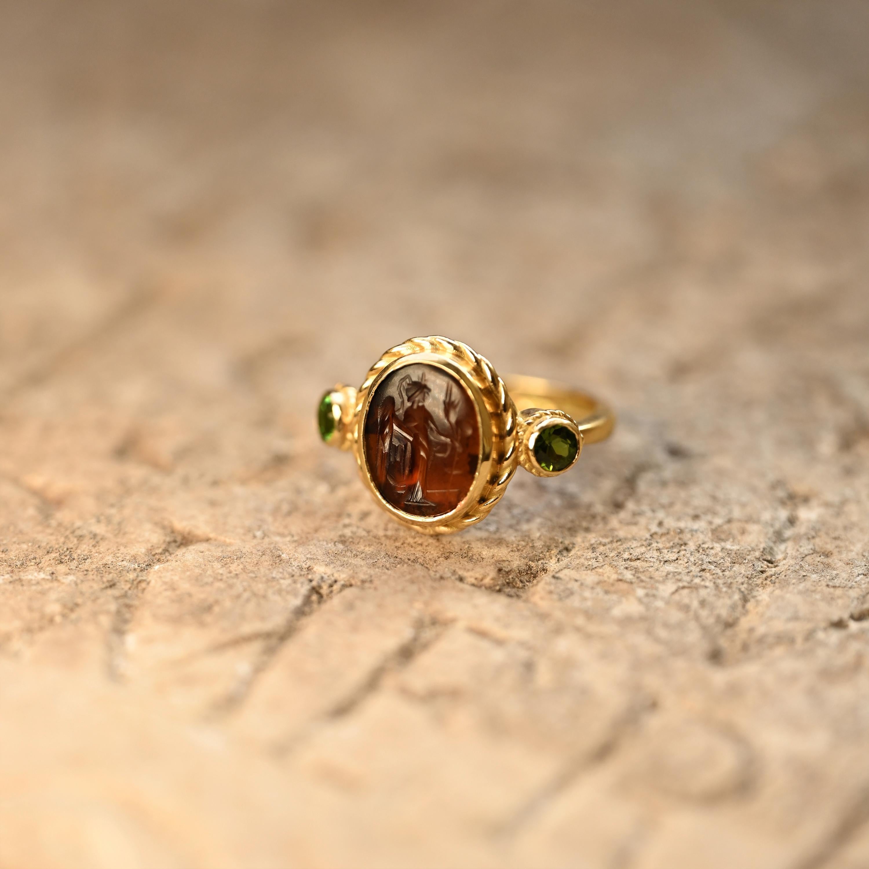 This 18Kt gold ring showcases an authentic Roman carnelian, tracing its origins to the 1st-2nd century A.D. Adorned with the image of Demeter, known as Ceres in Roman mythology, this exquisite piece showcases her classical attributes: ears of wheat,