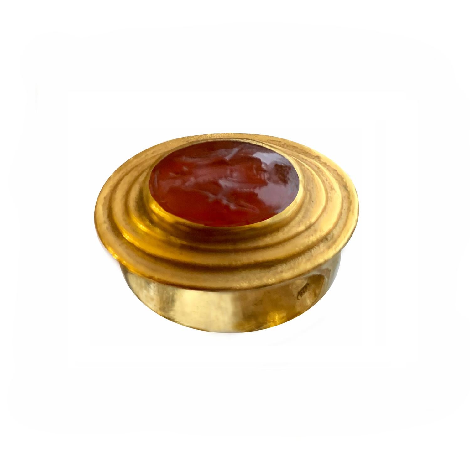 In this 18 kt  gold ring an authentic roman  intaglio on carnelian ( 1st cent.AD ), depicting God Hermes  ( Mercury for Romans ) is set.

Mercury/Hermes is a major God in Roman religion and mythology, being one of the 12 Consentes within the ancient