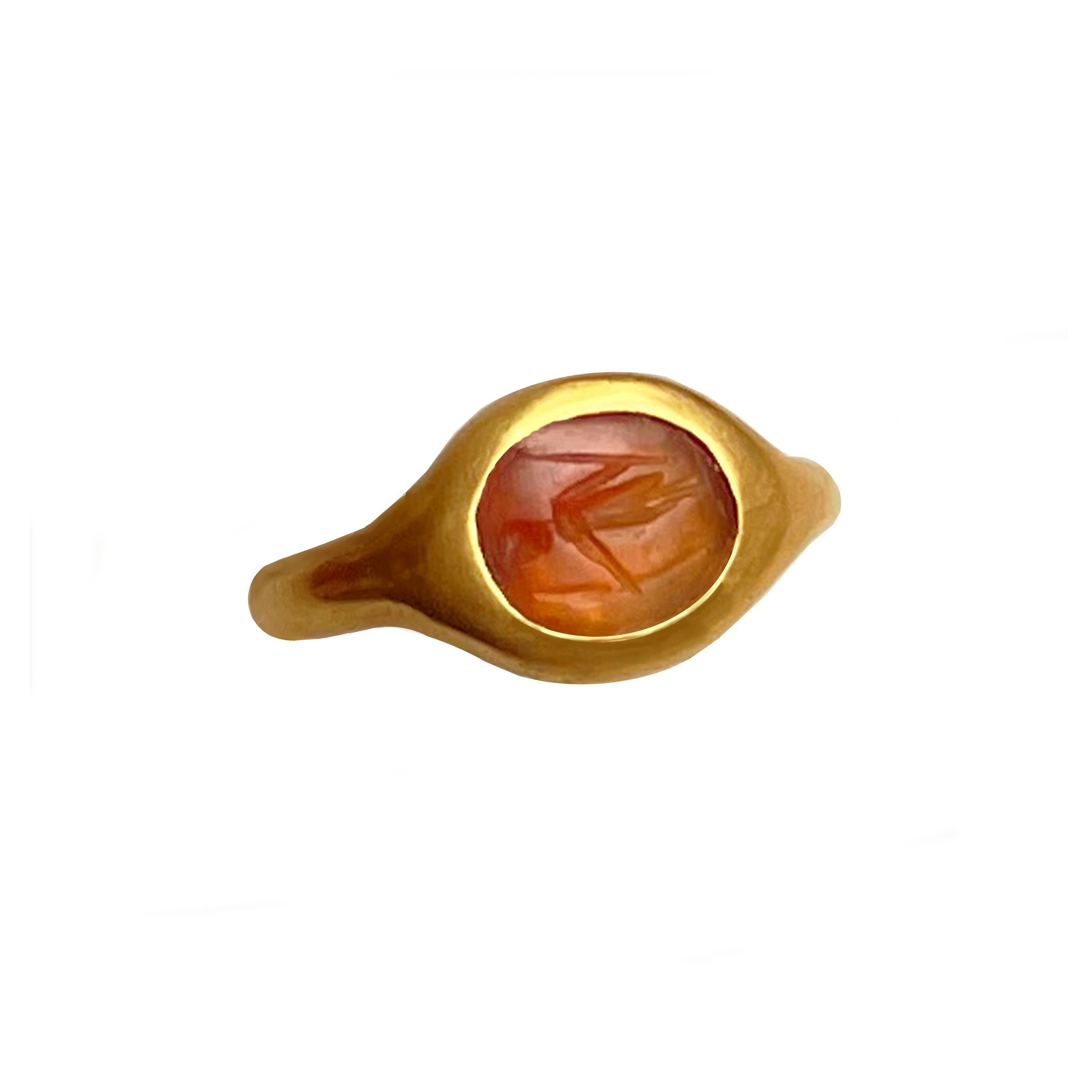 In this 18 Kt gold ring ( ring size 5.75   ) an authentic Roman carnelian (2nd century AD) has been set which depicts the goddess Athena with her classic attributes: the spear and the shield.
Athena is the Olympian goddess of wisdom and war and the