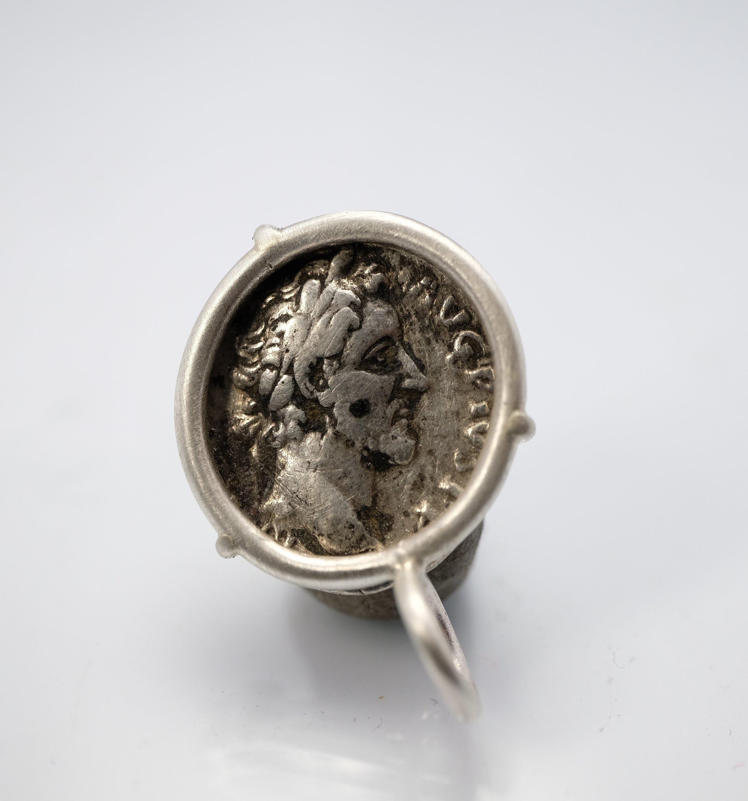 To appreciate the pendant's size, the relief of the coin and the shape of the bail, see the picture showing the coin next to a US quarter (will post soon). The coin was first set in a sterling silver bezel, which was then hammered over the edge of