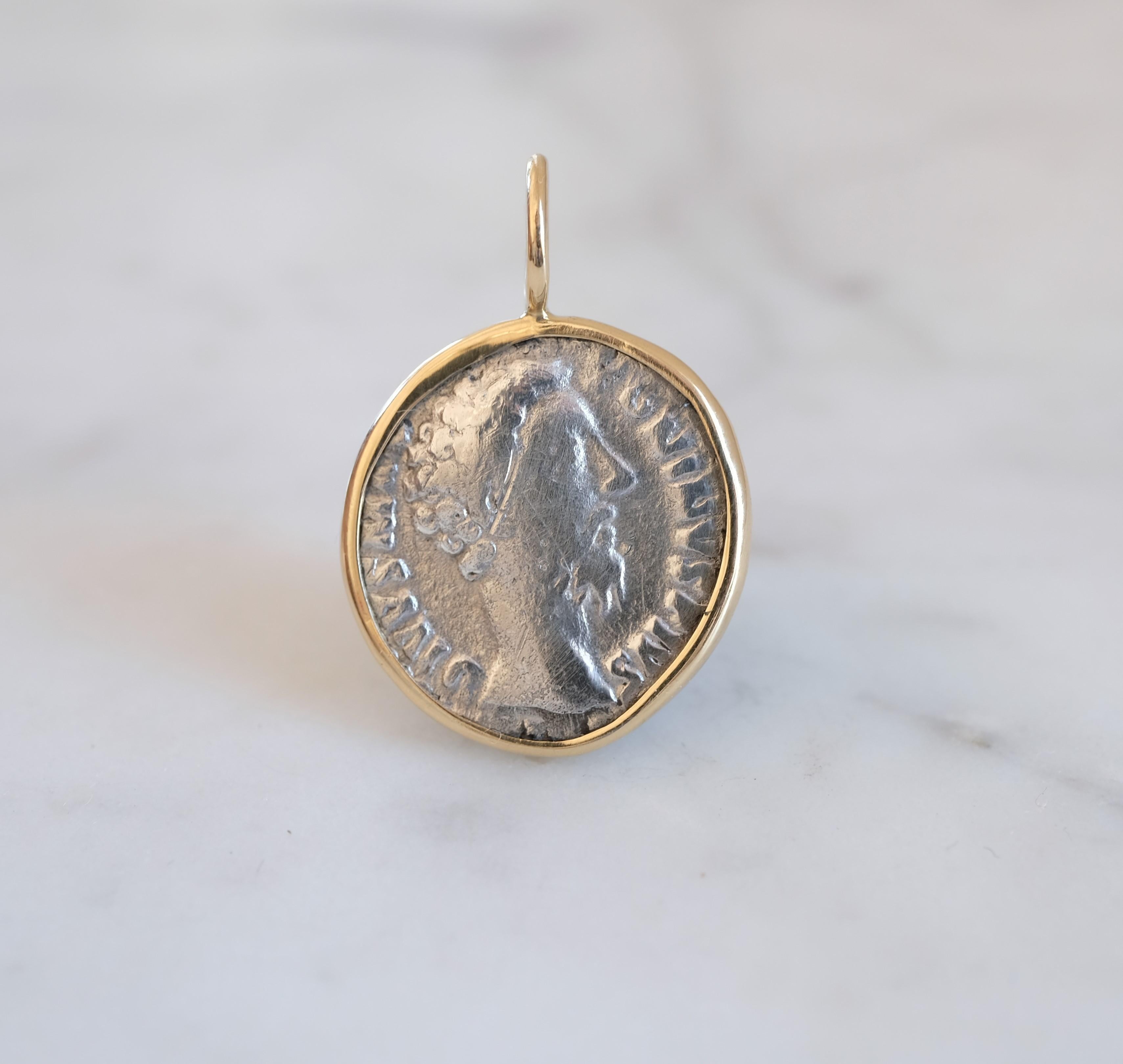 To appreciate the pendant's size, the relief of the coin and the shape of the bail, see the picture showing the coin next to a US quarter. The coin was first set in a gold bezel, which was then hammered over the edge of both sides. This was then