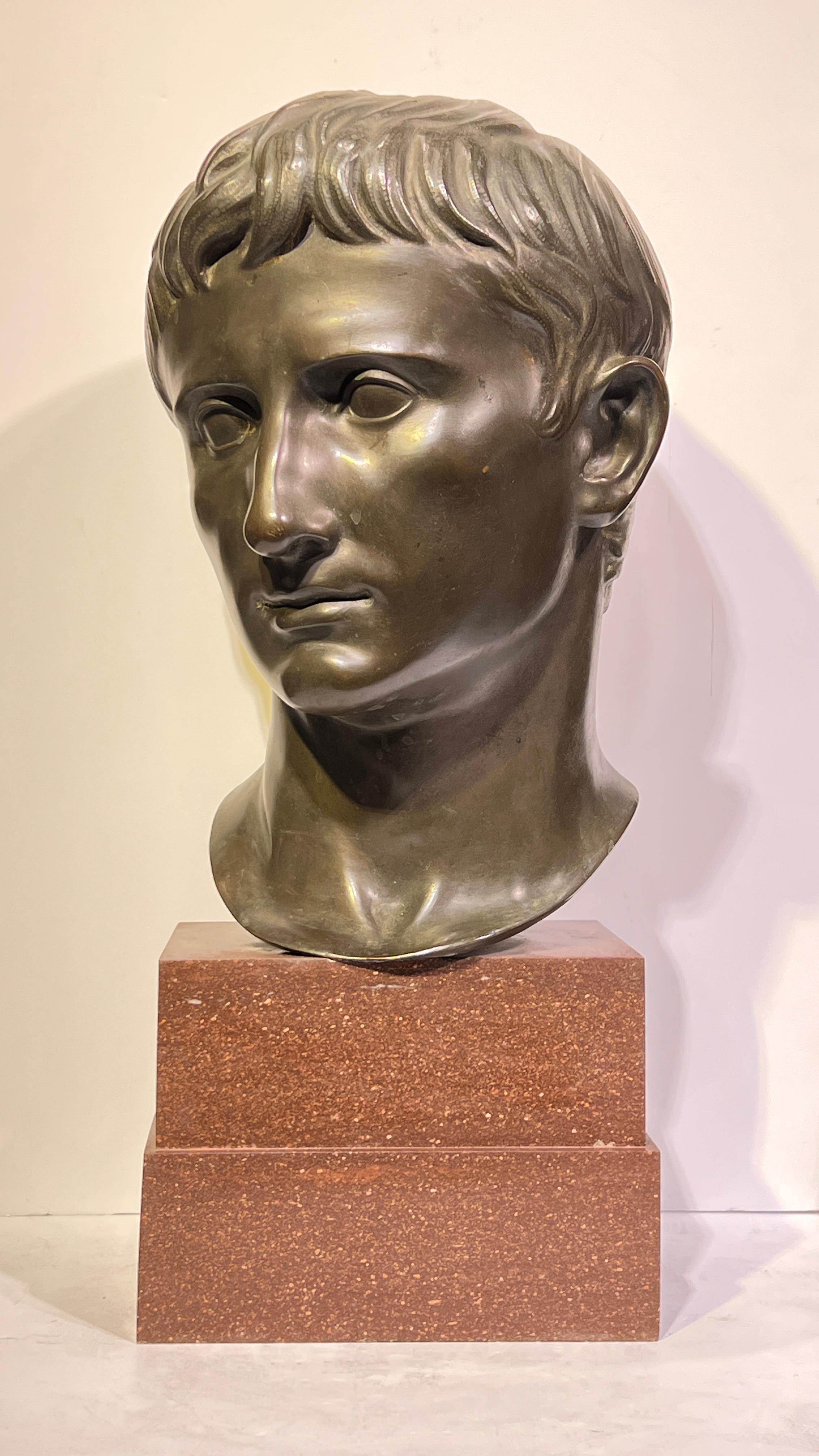 Grande busto in bronzo patinato del Grand Tour, finemente fuso, dell'imperatore romano Augusto, montato su una base a gradini in granito marrone rossastro con un'altezza totale di 20 pollici, apparentemente non firmato.

Ispirata alla Testa di