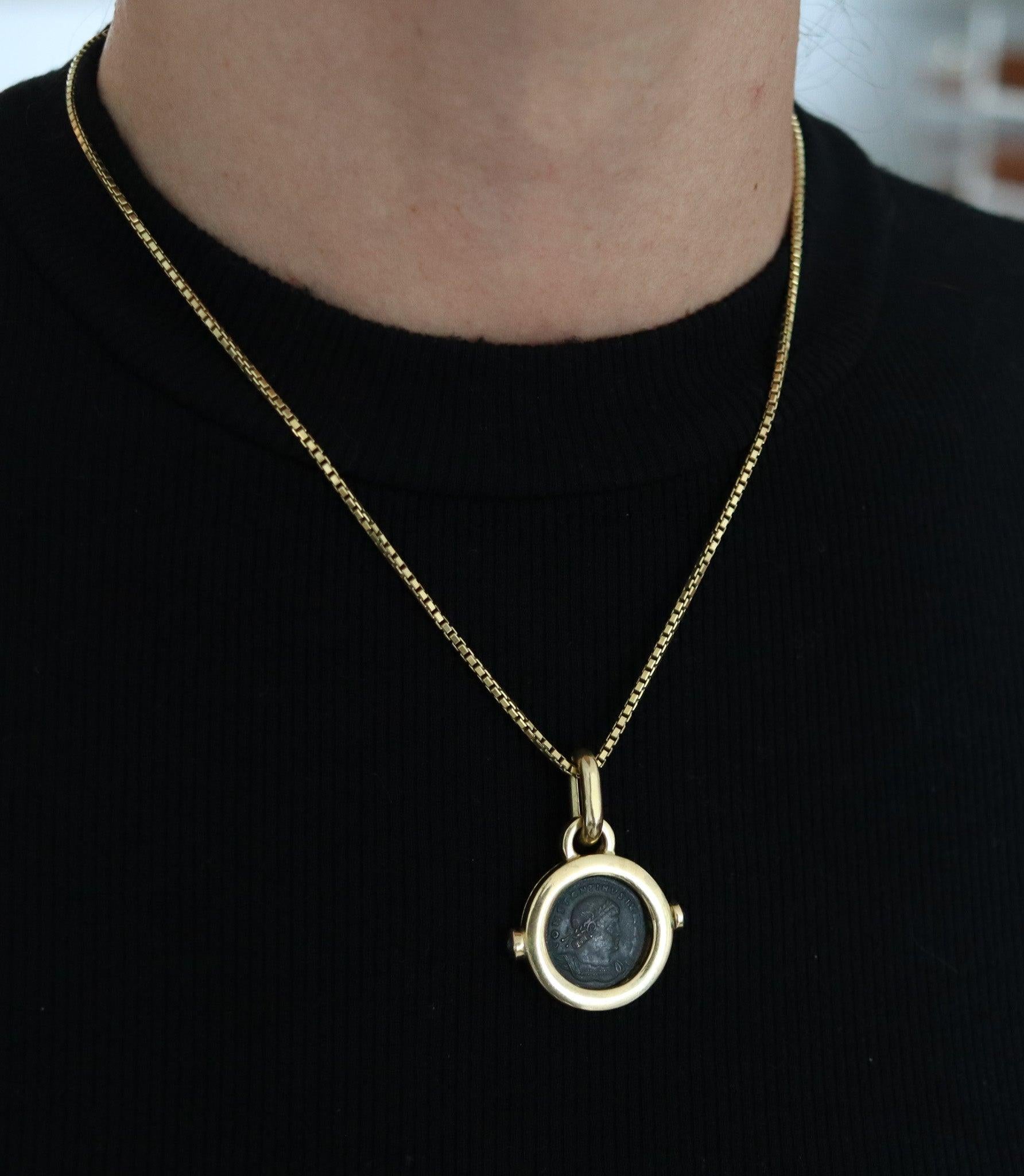 An ancient Roman coin pendant designed by Fratelli Terziani.

This is an elegant pendant displaying an ancient Roman coin created in the city of Arezzo Italy at the goldsmith’s atelier of Fratelli Terziani, back in the late 1970's. The pendant's