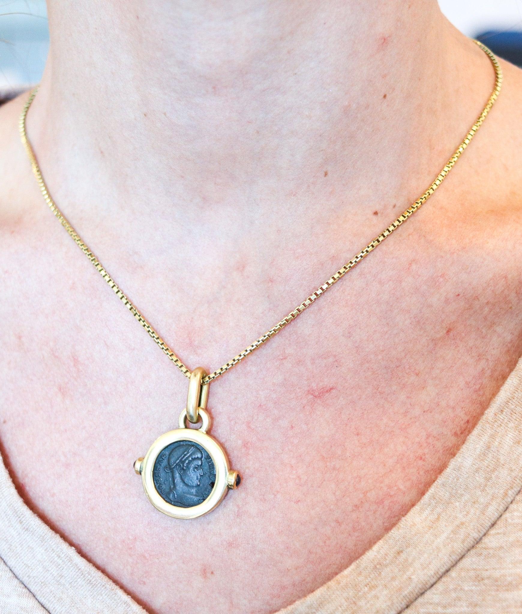 Roman ancient coin pendant designed by Fratelli Terziani.

This is an elegant pendant displaying an ancient Roman coin created in the city of Arezzo Italy at the goldsmith’s atelier of Fratelli Terziani, back in the late 1970's. The pendant's frame