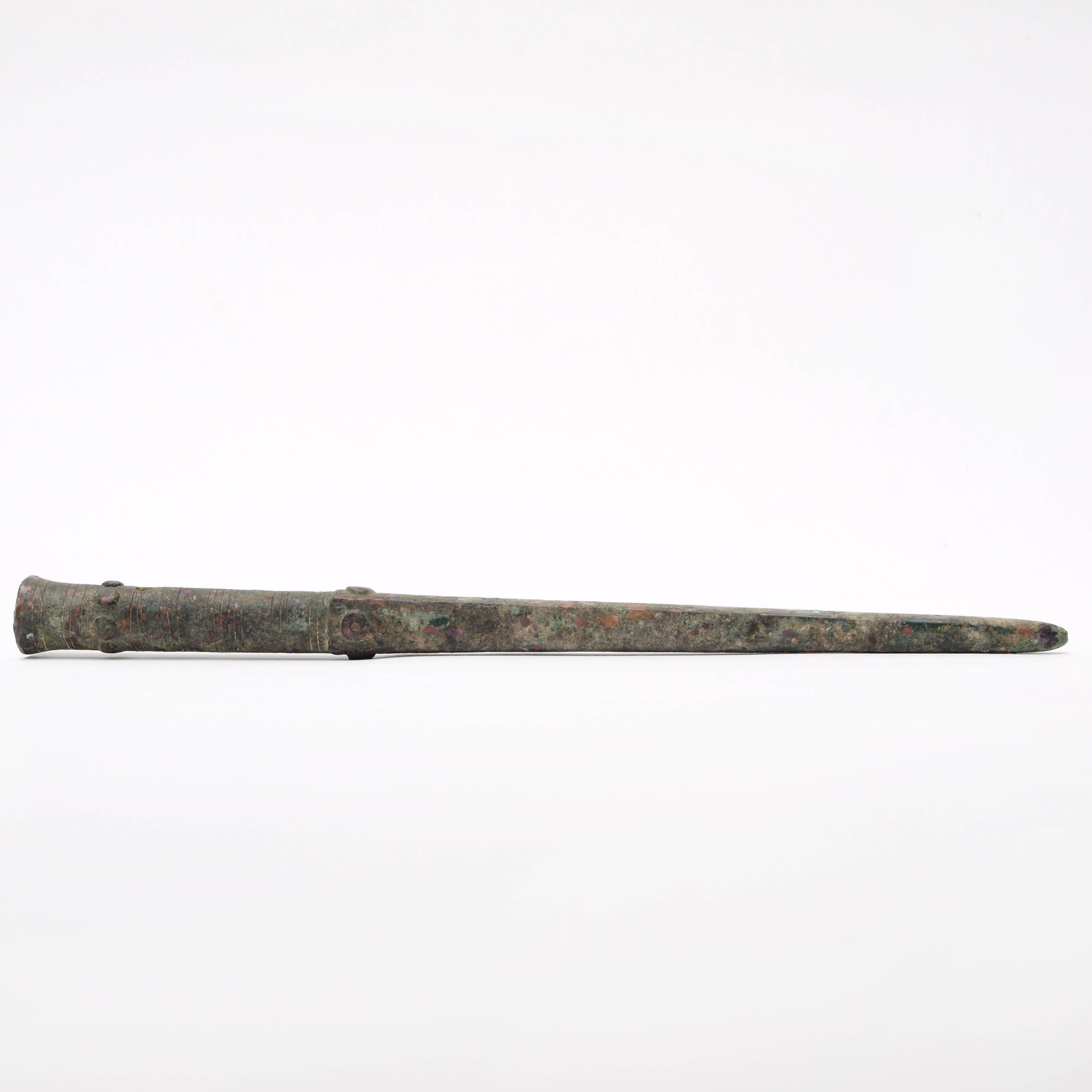 An ancient Roman bronze sauroter or butt spike for a spear or standard with incised lines and raised boss detailing around the socket.