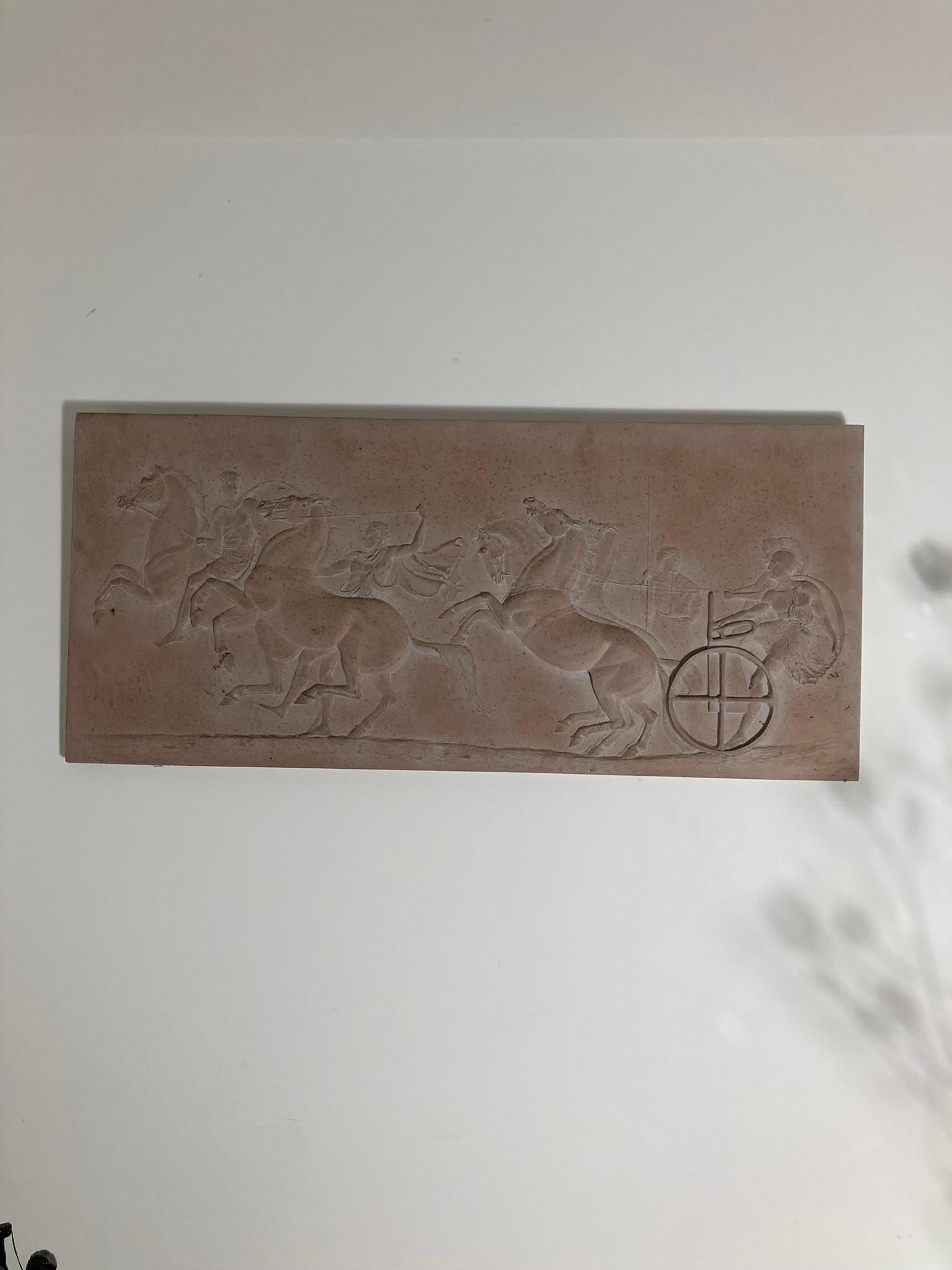 Plaster Frieze chariot driver and Horses competing an Aphobates Contest Athens. An apobates contest is in which chariots were drawn by teams of four horses, driven by a charioteer and carried an armed warrior. As the chariot raced along the course