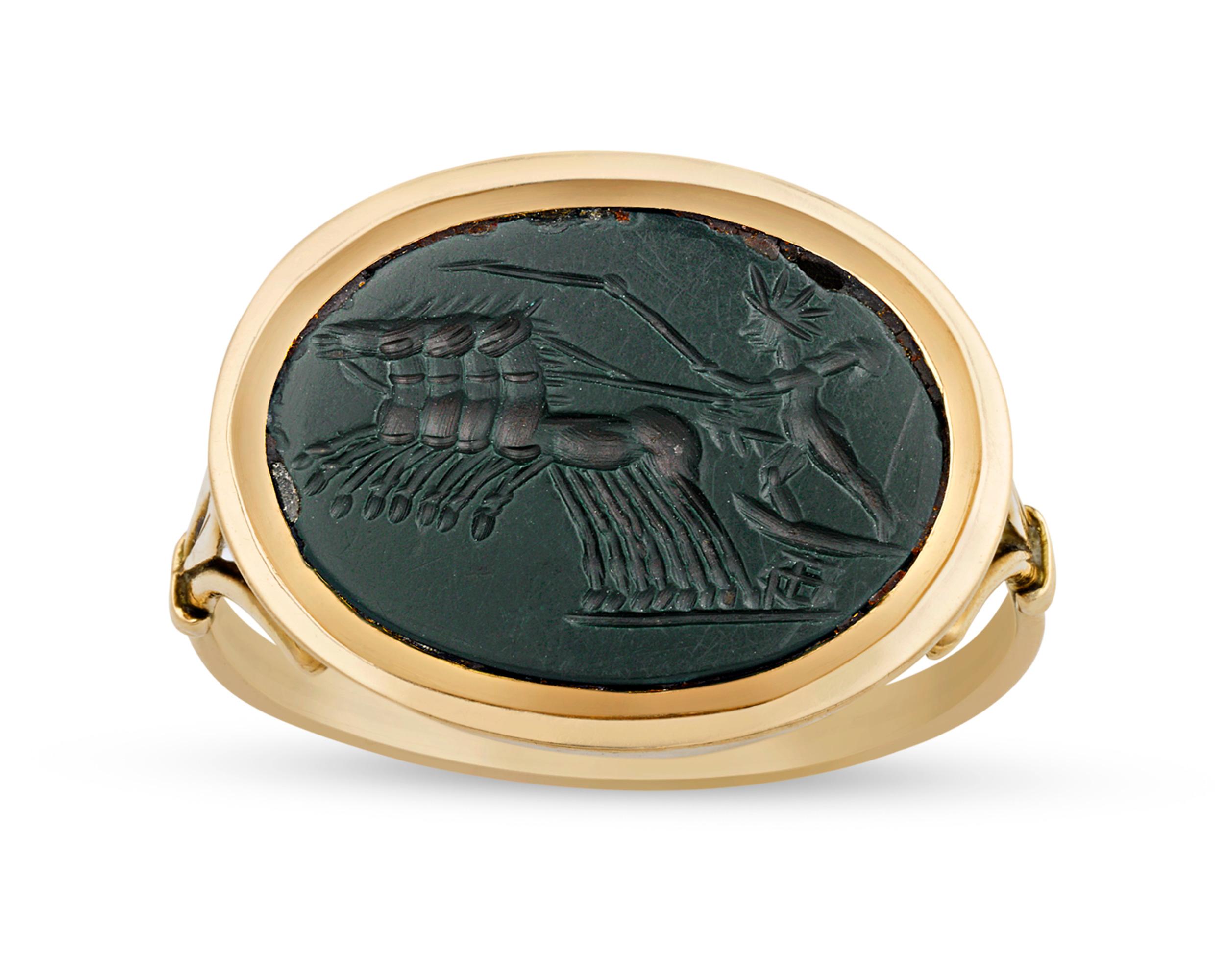 This remarkably rare Roman green jasper gem is carved in intaglio with a scene depicting the sun god Helios in his chariot. According to mythology, Helios traversed the sun in his golden chariot during the day, and by night sailed the ocean in a