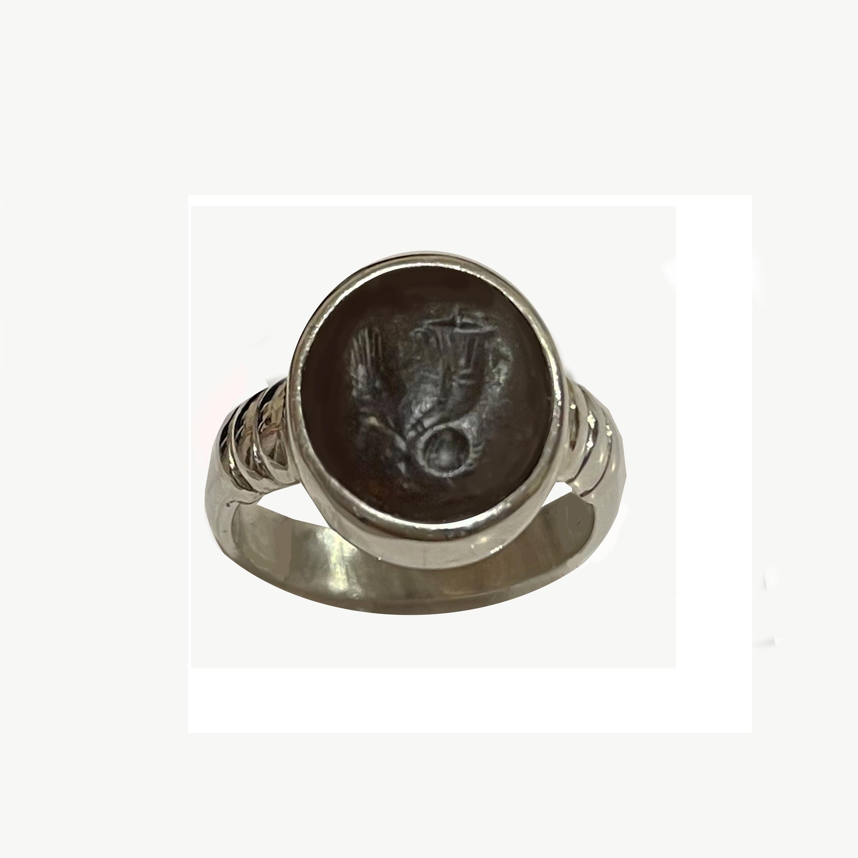 In this  extraordinary sterling silver ring has been set  an authentic Roman (1st-2nd century AD) intaglio on agate with the allegorical symbols of luck and abundance: a cornucopia, an ear and a globe (representing the world). 
The Cornucopia,