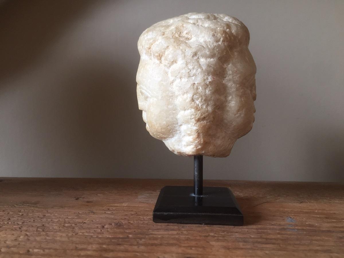 Small Roman marble janushead depicting two nearly identical cherubinheads on each side. The hair finely sculpted with the faces having a attractive expression.
Janus was one of the oldest Roman gods and represented the concept of beginning and end
