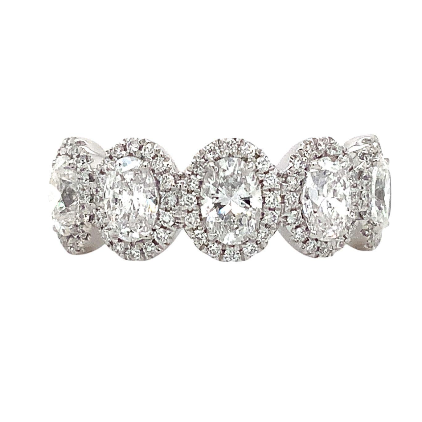  

Roman + Jules 5 Stone Oval Diamond Halo Band set in Platinum totals 1.77 cts t.w. Perfect for stacking, anniversaries, or as a right-hand ring, this piece makes a sophisticated, yet feminine statement. Five oval diamonds weighing 1.50 cts t.w.