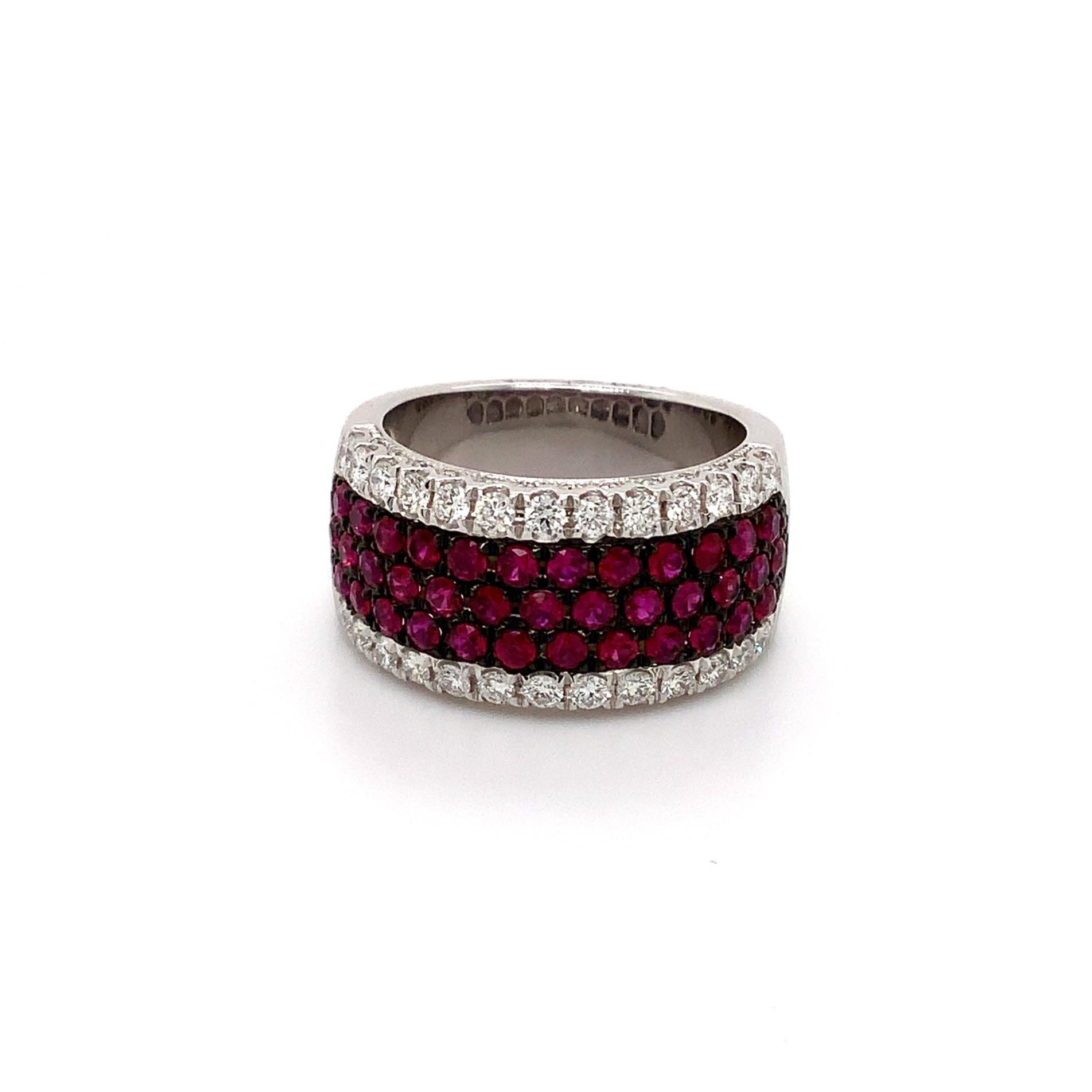 Roman + Jules Pavé Ruby And Diamond Five Row Cigar Band set in 14K White Gold with Black Rhodium Detailing.
50 Round Brilliant Cut Diamonds Equal 0.60 tw
G in Color SI in Clarity
Excellent Make and Polish.
41 Round Rubies Equal 1.29 cts.