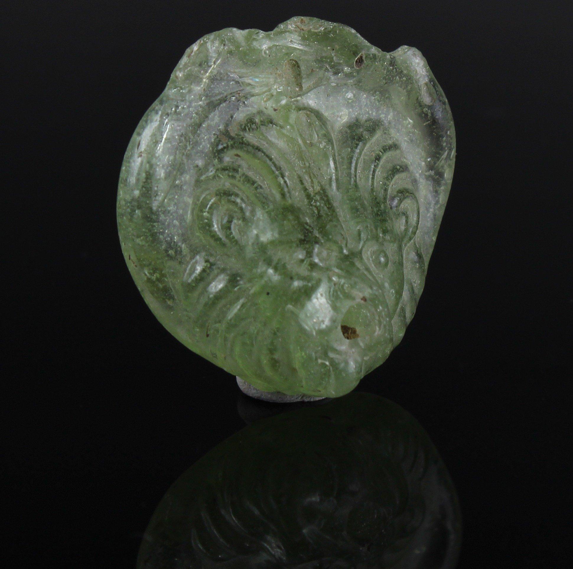 ITEM: Lion medallion
MATERIAL: Glass
CULTURE: Roman
PERIOD: 2nd – 3rd Century A.D
DIMENSIONS: 15 mm x 37 mm diameter
CONDITION: Good condition
PROVENANCE: Ex Shlomo Moussaieff collection, Herzliya Pituah, with export approval 55883
PARALLEL: CORNING