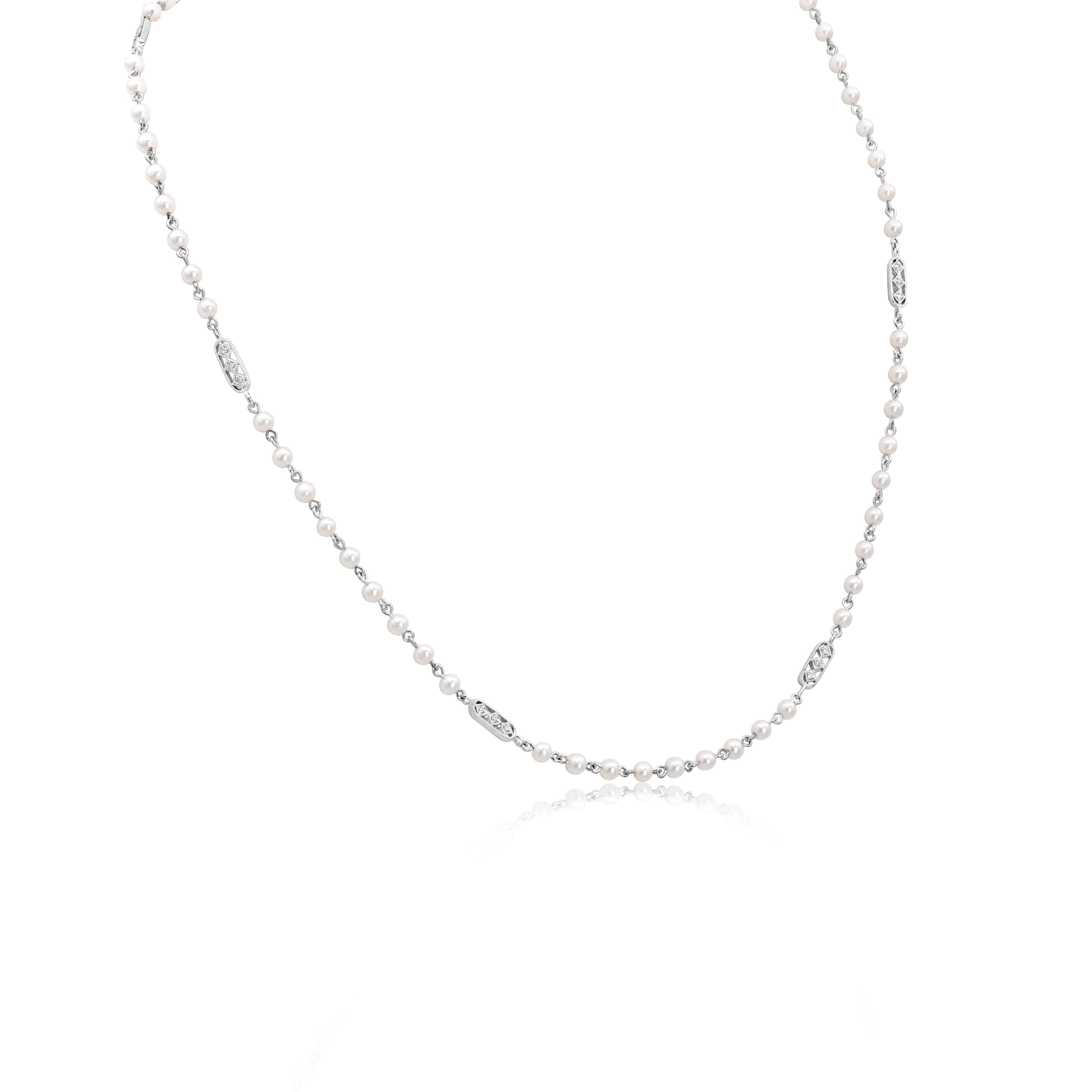 An elegant necklace, featuring round cut diamonds weighing 0.13 carat total, set on square shape bezels in groups of three. Finished with milgrain edges and accented by small white pearls. Finely made with 18K white gold, 17 inches in length.