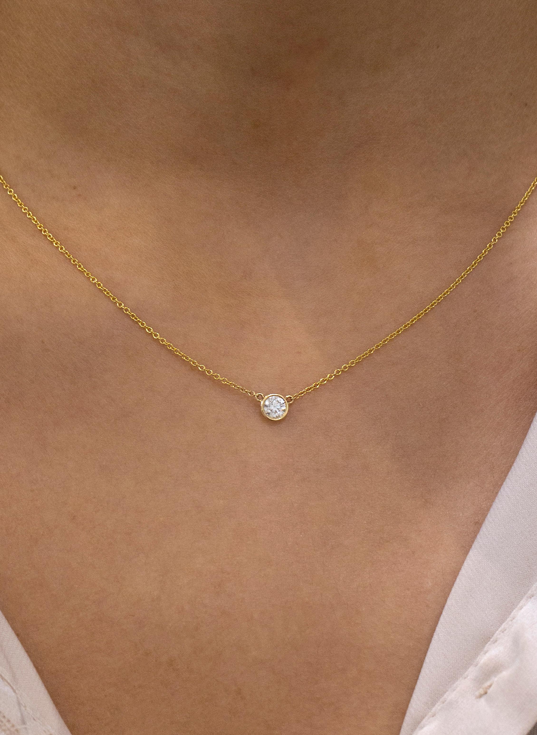 A simple and versatile solitaire pendant necklace showcasing a single 0.26 carat round diamond, 
F color SI2 clarity. In a 14 karat Yellow Gold bezel. Attached to a 16 inch with an interval at 15 inch in 14k Yellow Gold chain. 

Roman Malakov is a