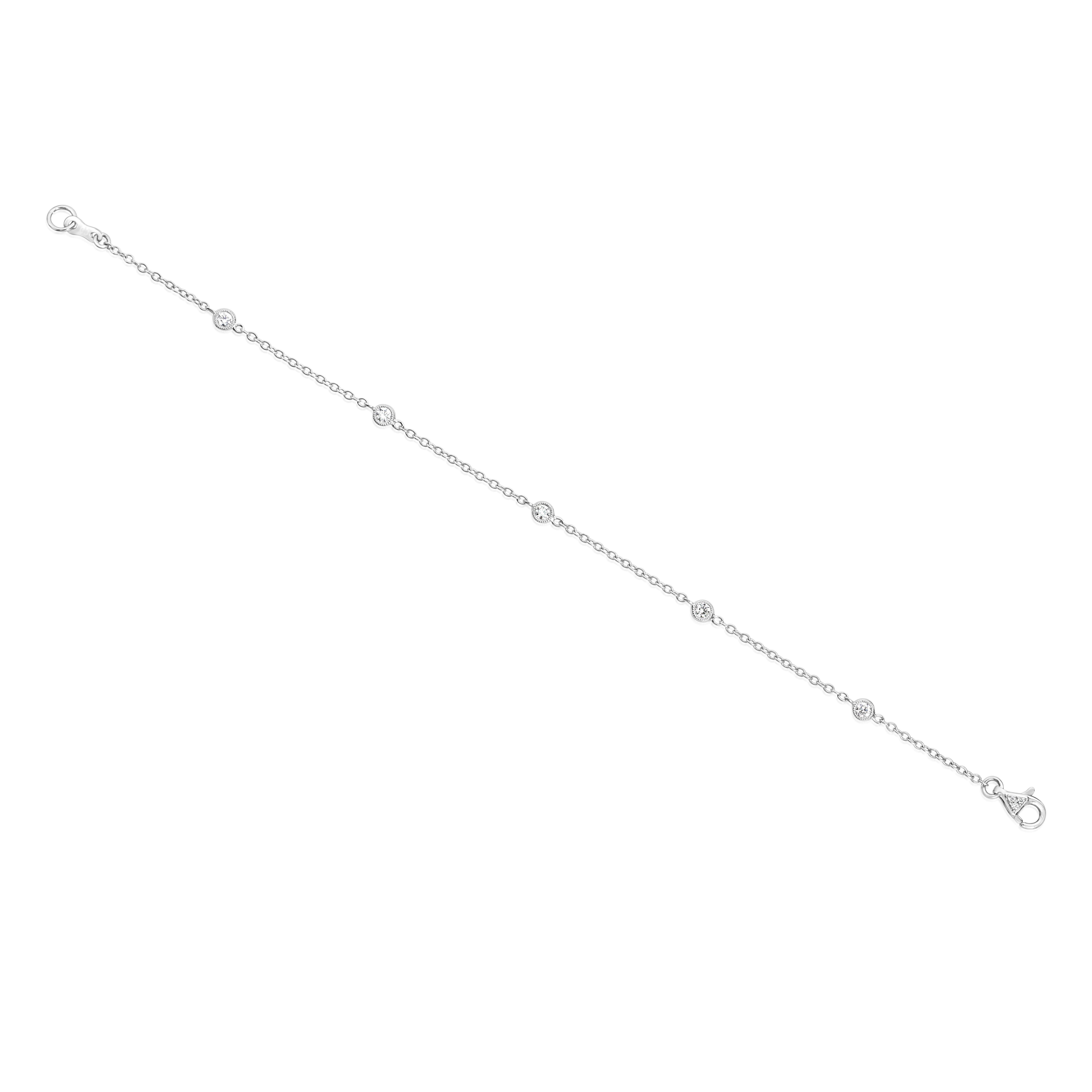 A stylish fashion bracelet, featuring round brilliant cut diamonds weighing 0.26 carat total, bezel-set with milgrain edges. Lobster clasp is accented by a cluster of round cut melee diamonds. Finely made with 18K white gold, 7 inches in length.