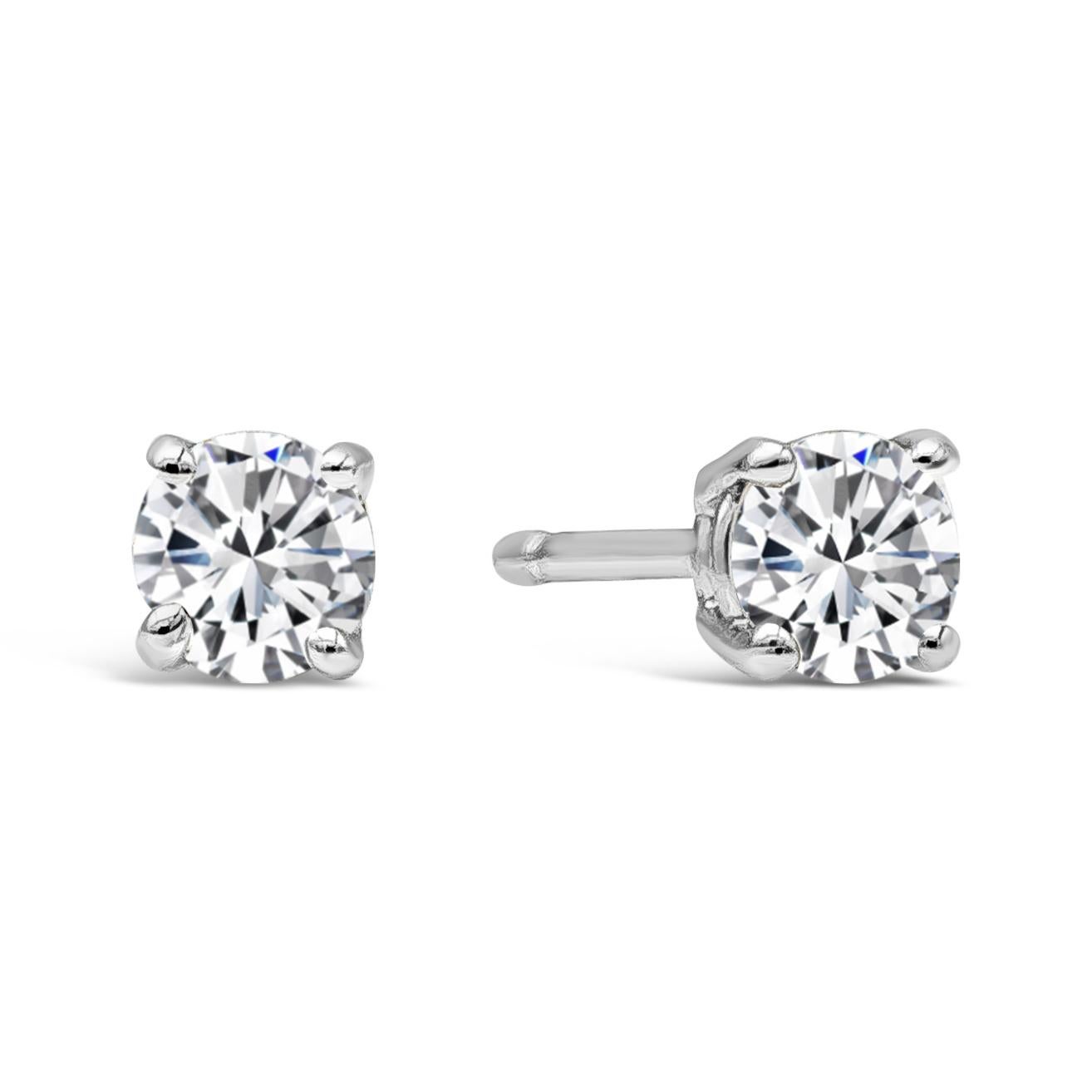 Two perfectly matched timeless stud earring set into a refined four prong mounting with standard friction backs to match any style. Perennial stud earrings showcasing 0.30 carat round brilliant diamonds. Color is G and Clarity is SI. Flawlessly made