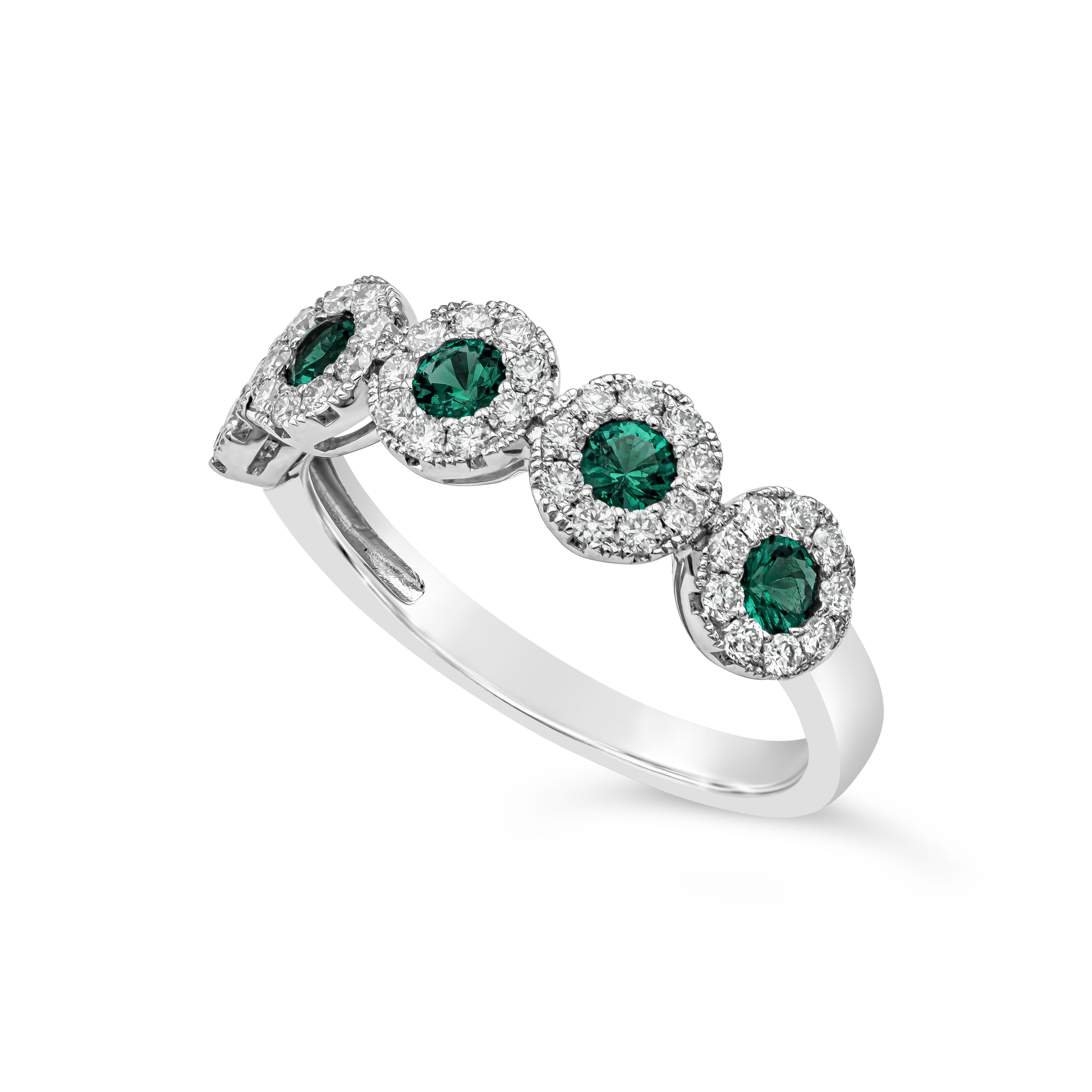 A fashionable and chic style ring showcasing 5 vibrant green emerald surrounded by 45 round brilliant diamonds. Set in 18 karat white gold. Green emerald weigh 0.35 carats total; diamonds weigh 0.39 carats total, FG color and VS/SI clarity.

Roman