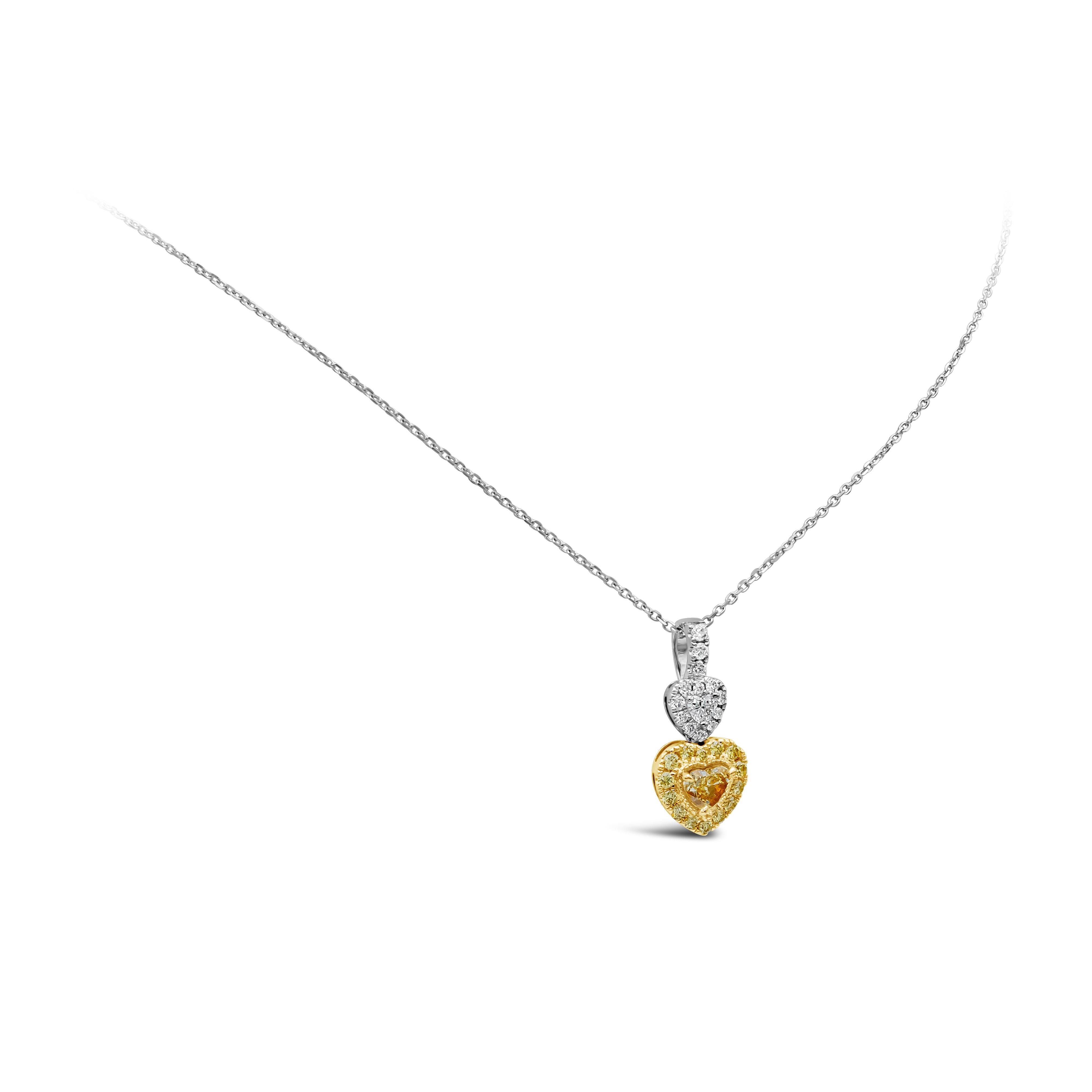 This beautiful pendant necklace that has a 0.32 carat heart shape fancy yellow diamond with VS clarity and is surrounded by 14 yellow brilliant round diamonds that weighs at 0.17 carat total with VS/SI clarity. On top is 0.08 carat heart shape white