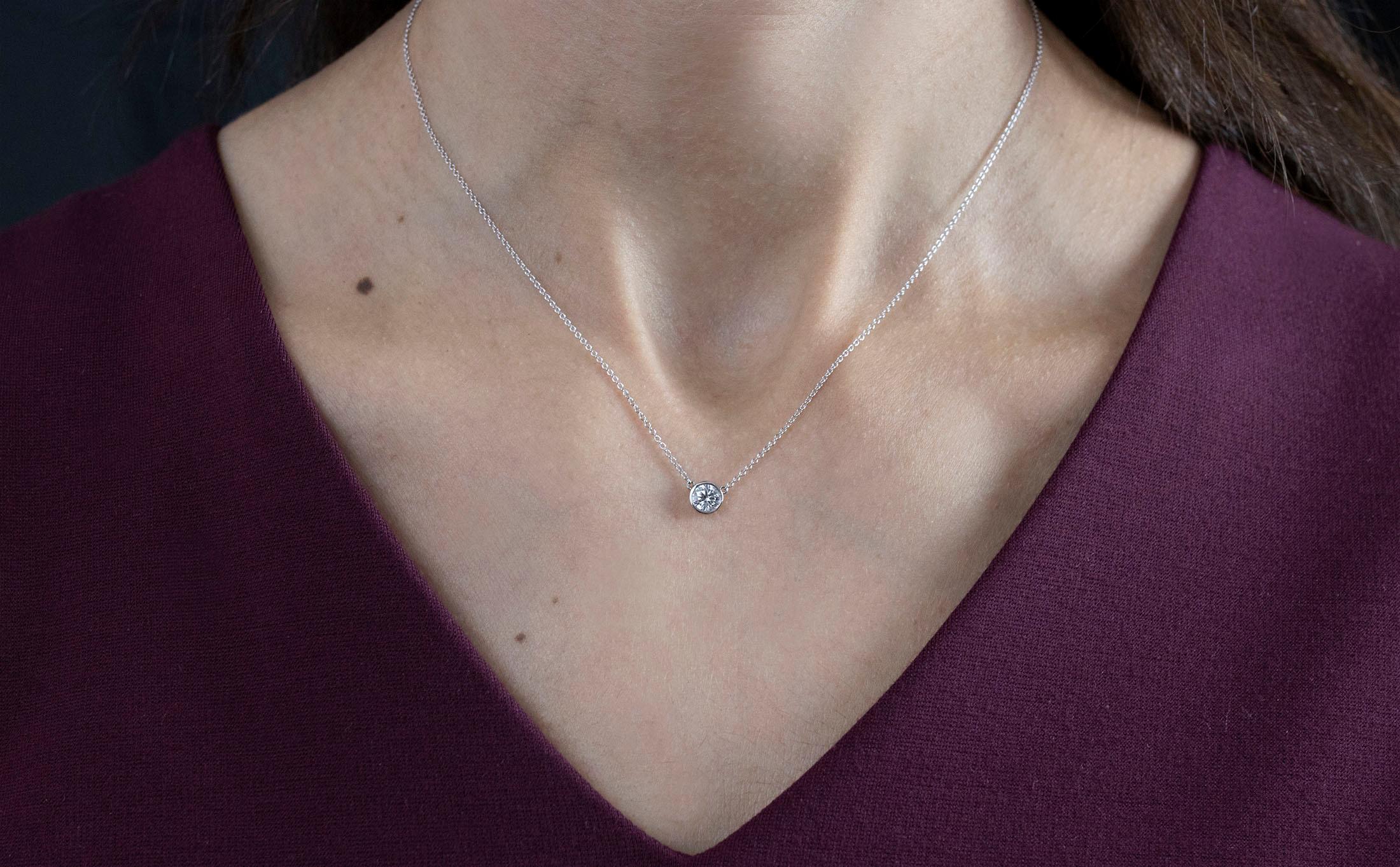 A simple and versatile solitaire pendant necklace showcasing a single 0.42 carat round diamond in a 14K White Gold bezel. Attached to a 16 inch with an interval at 15 inch White Gold chain. 

Style available in different price ranges. Prices are