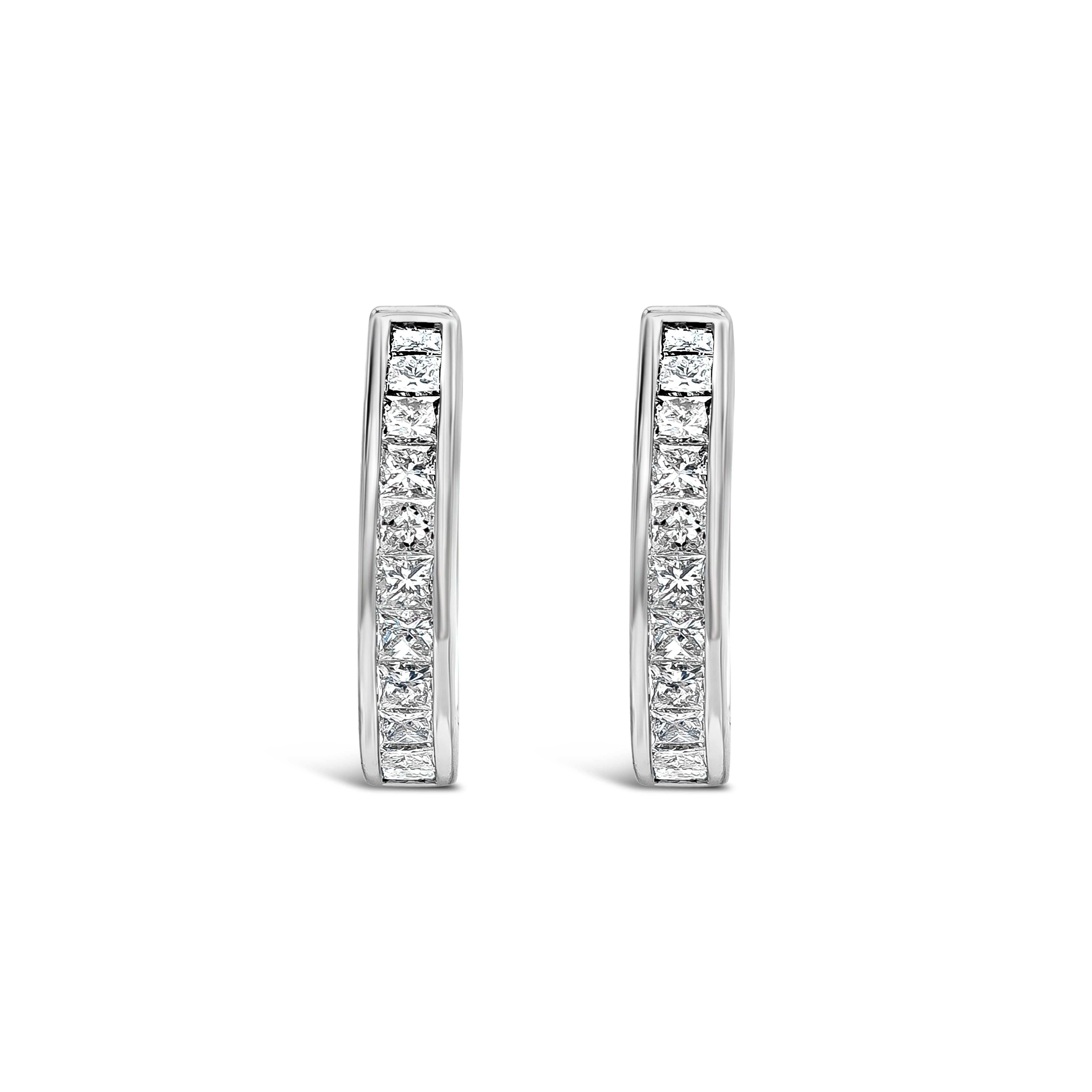 A simple pair of hoop earrings showcasing a row of 22 princess cut diamonds, channel set in an 18k white gold mounting. Diamonds weigh 0.50 carats total, F color and VS in clarity.

Style available in different price ranges. Prices are based on